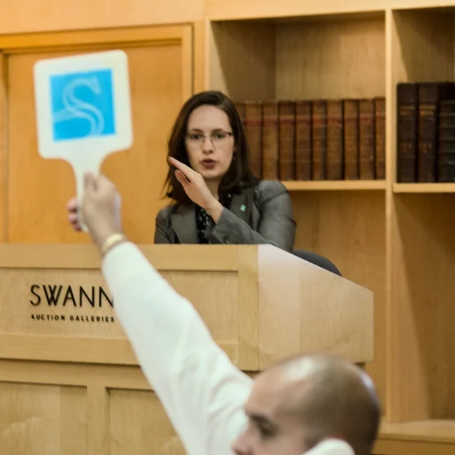 Communications Director Alexandra Nelson auctioneering.