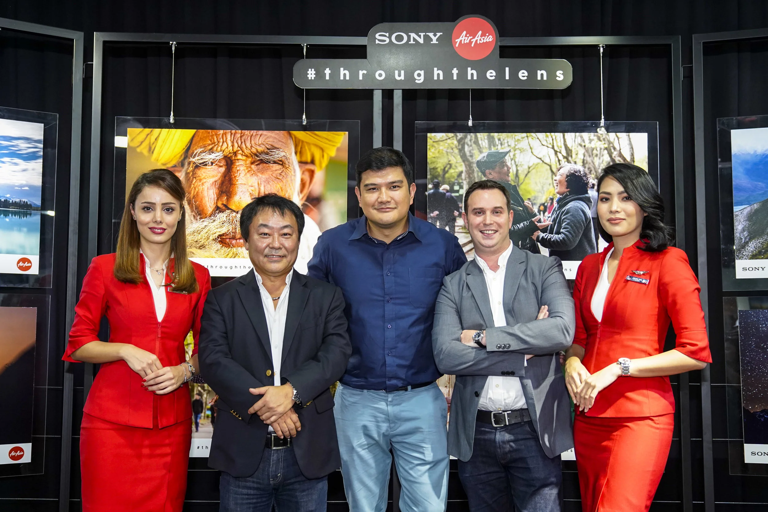 Photo Caption: (From Left to Right) Sony Malaysia Managing Director Satoru Arai; AirAsia X Malaysia CEO Benyamin Ismail and AirAsia X Group Head of Commercial Barry Klipp flanked by cabin crew at the launch of “Through the Lens” to search for a joint ambassador for the brands.