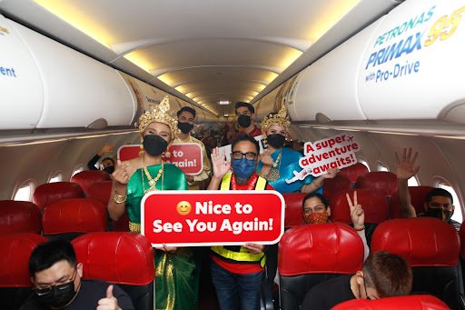  Photo Caption: Riad Asmat, CEO of AirAsia Malaysia together with AirAsia's Cabin Crew decked in traditional Khmer attire, pose with excited guests onboard flight AK 540 from Kuala Lumpur to Siem Reap. 