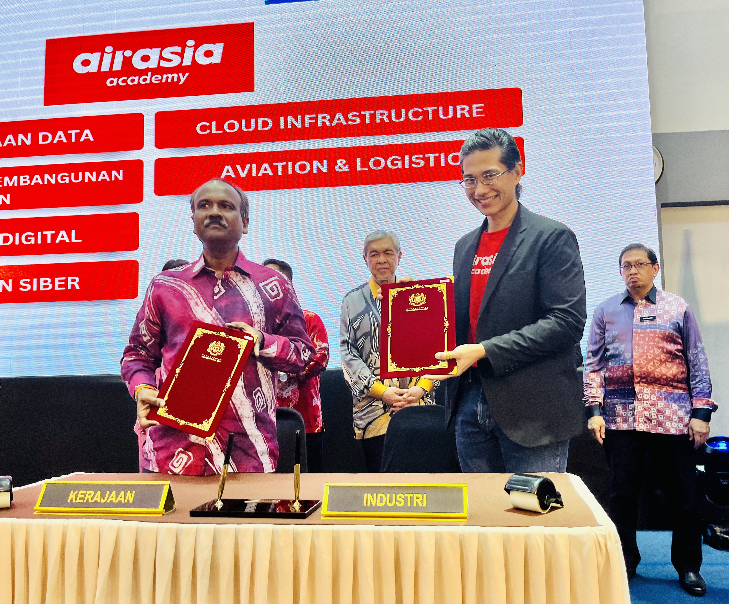   Photo caption:  Director of Strategy &amp; Innovation of airasia academy, Dr Ram Gopal Raj and Human Resources Minister, V. Sivakumar exchanging the Memorandum of Cooperation (MOC) after the signing ceremony at the Industrial Training Institute of 