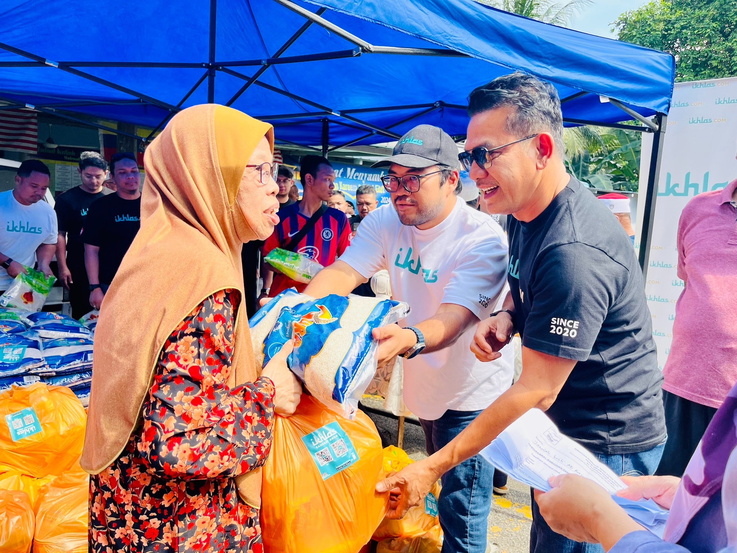  (Dari kanan) Datuk Rosyam Nor dan Ketua Pegawai Eksekutif ikhlas.com, Ikhlas Kamarudin menyerahkan bakul makanan mengandungi keperluan harian sempena kempen Sadaqah 1000 Bulan kepada penerima di Pantai Dalam, Kuala Lumpur. 