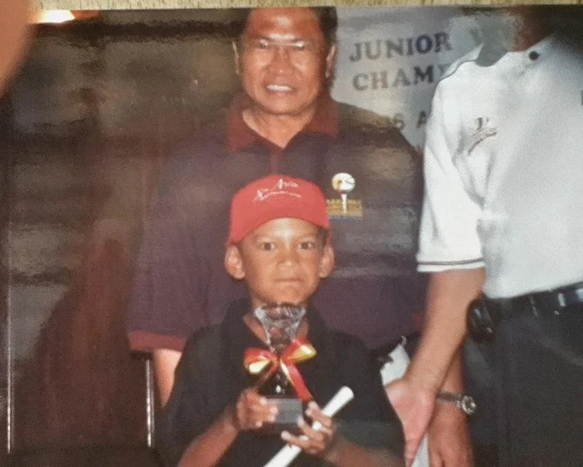 Rizal when he was 7 ½ years old, posing with the Most Talented Young Junior Golfer trophy.
