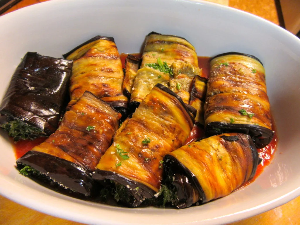 Place the eggplant rolls in baking dish. Spoon tomato sauce over the rolls and then top with the tomato olive mixture. Bake in 395 F. degree oven for 25 minutes. Take out of the oven and enjoy.