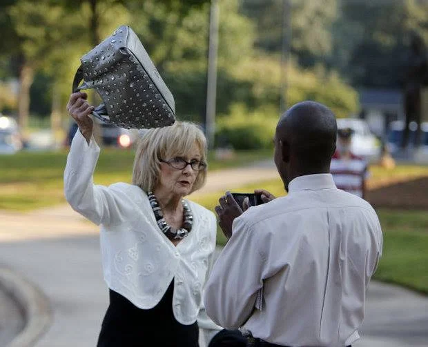 The infamous purse swing, circa Aug. 2013. If you look closely, you can see I was cracking a smile. Photo by Andy Burris. 