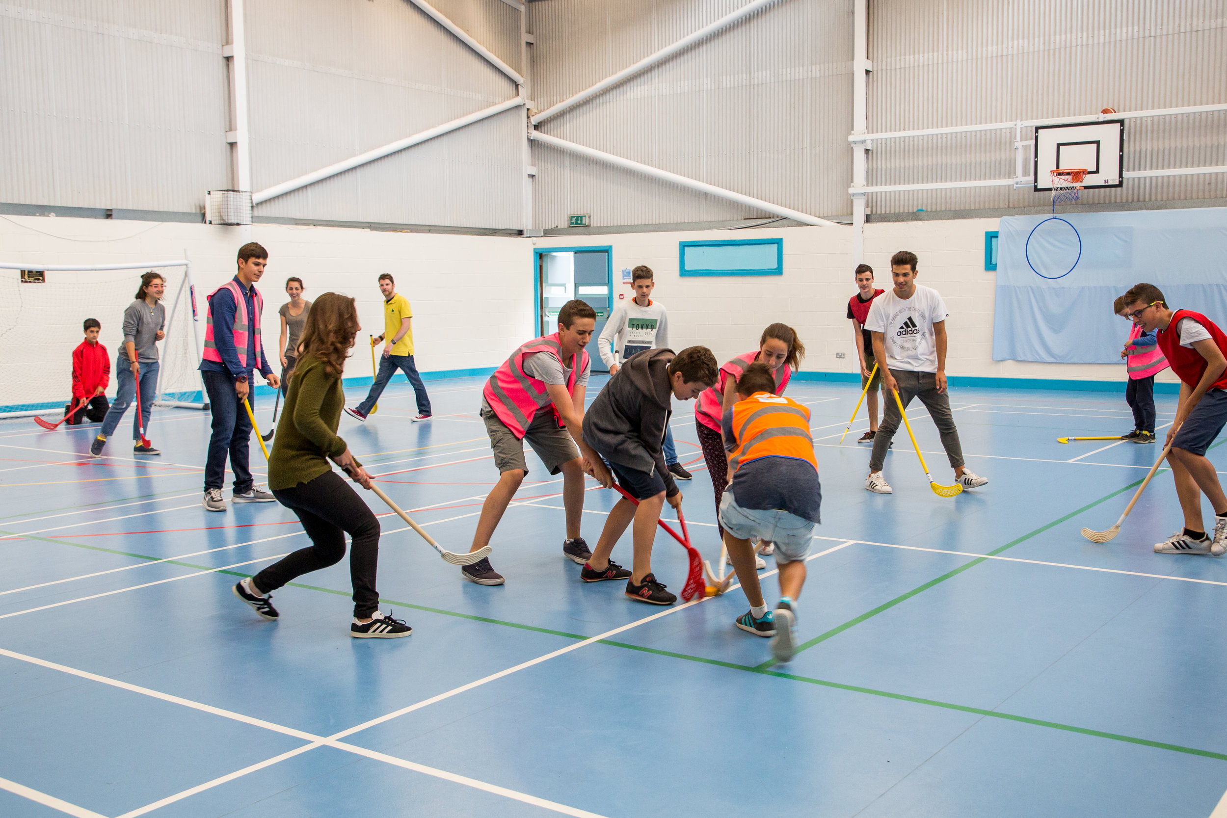 Students playing indoor hockey