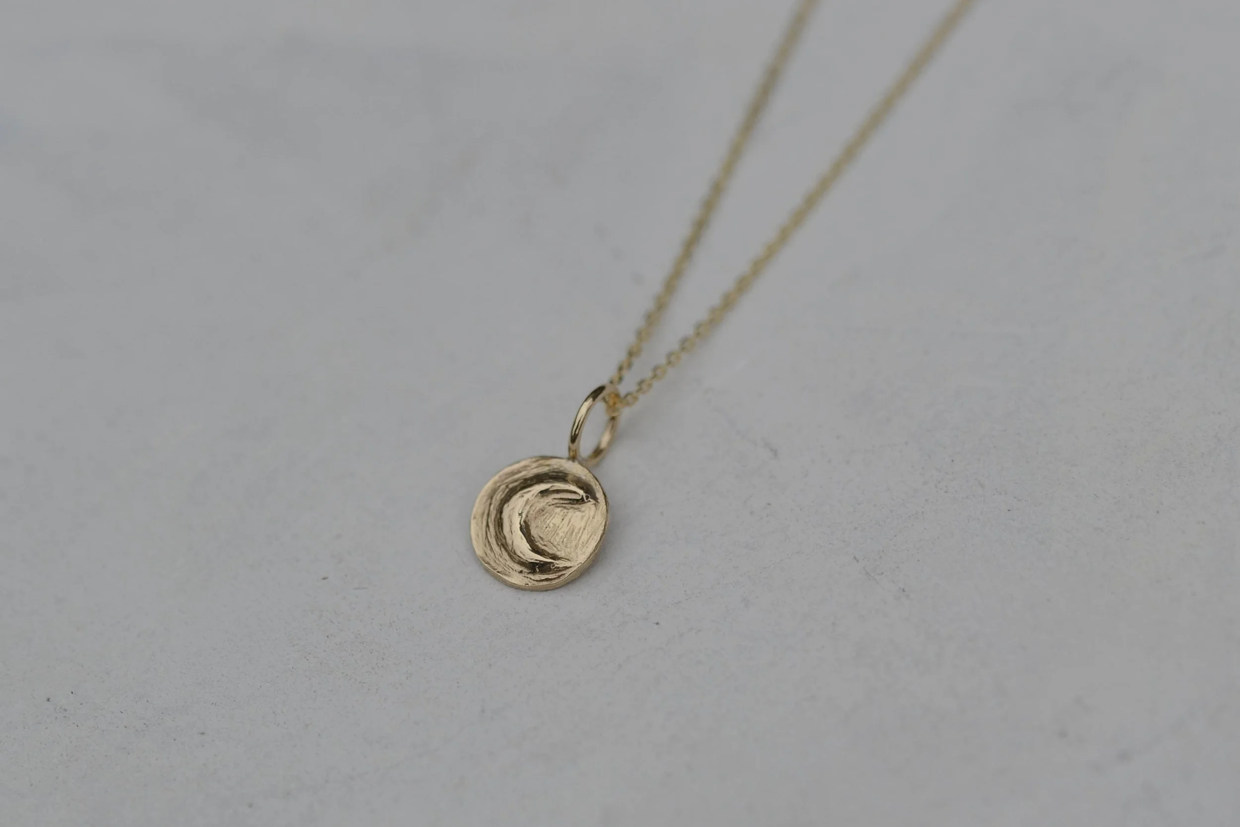 9ct gold coin pendant featuring a crescent moon