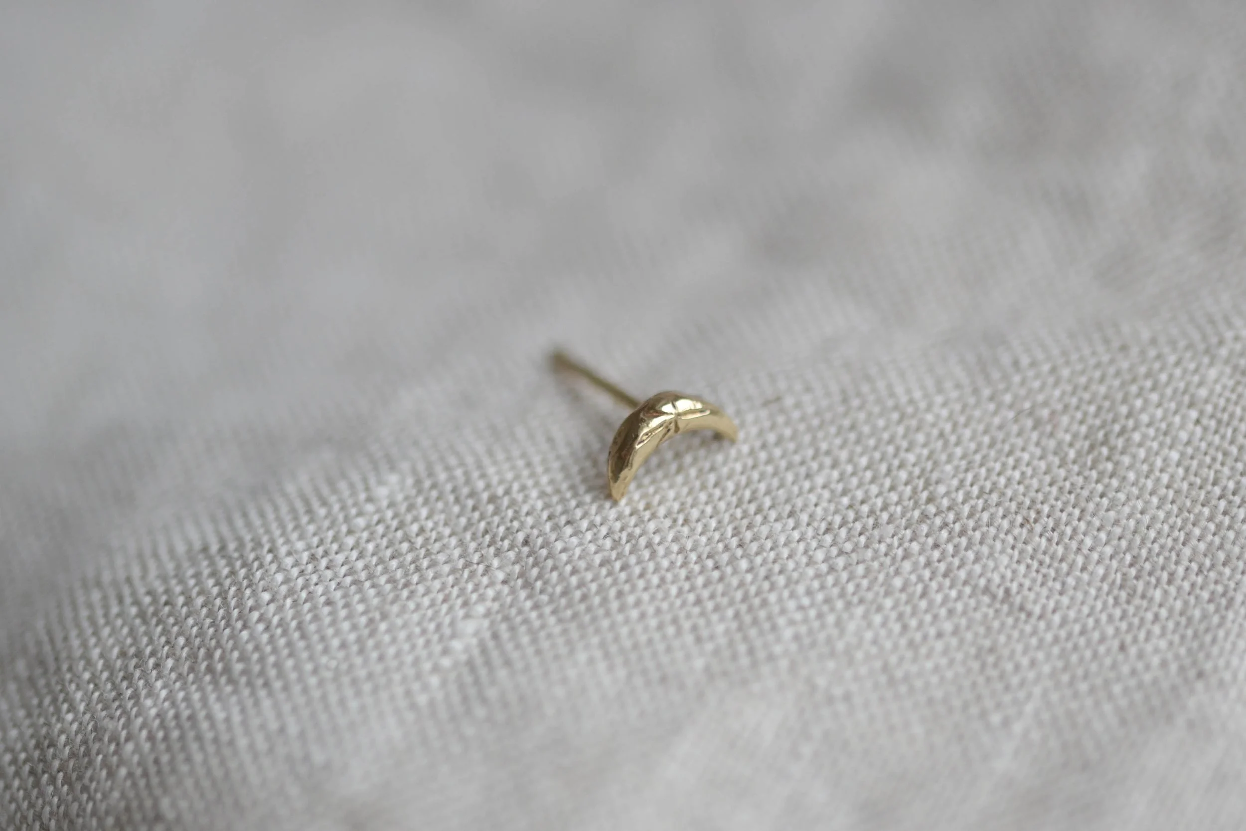 Textured moon stud from side angle