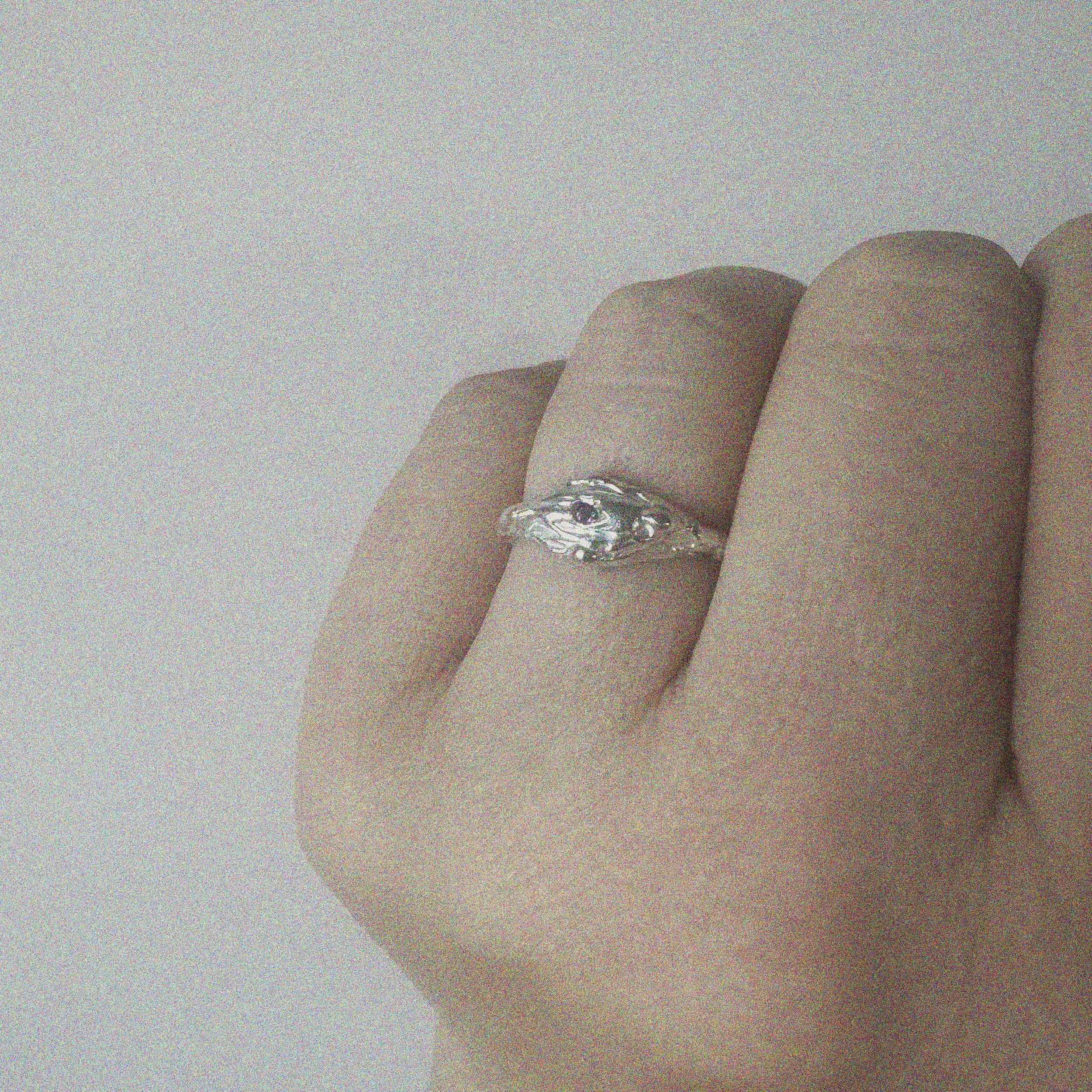 silver ring shown on a finger