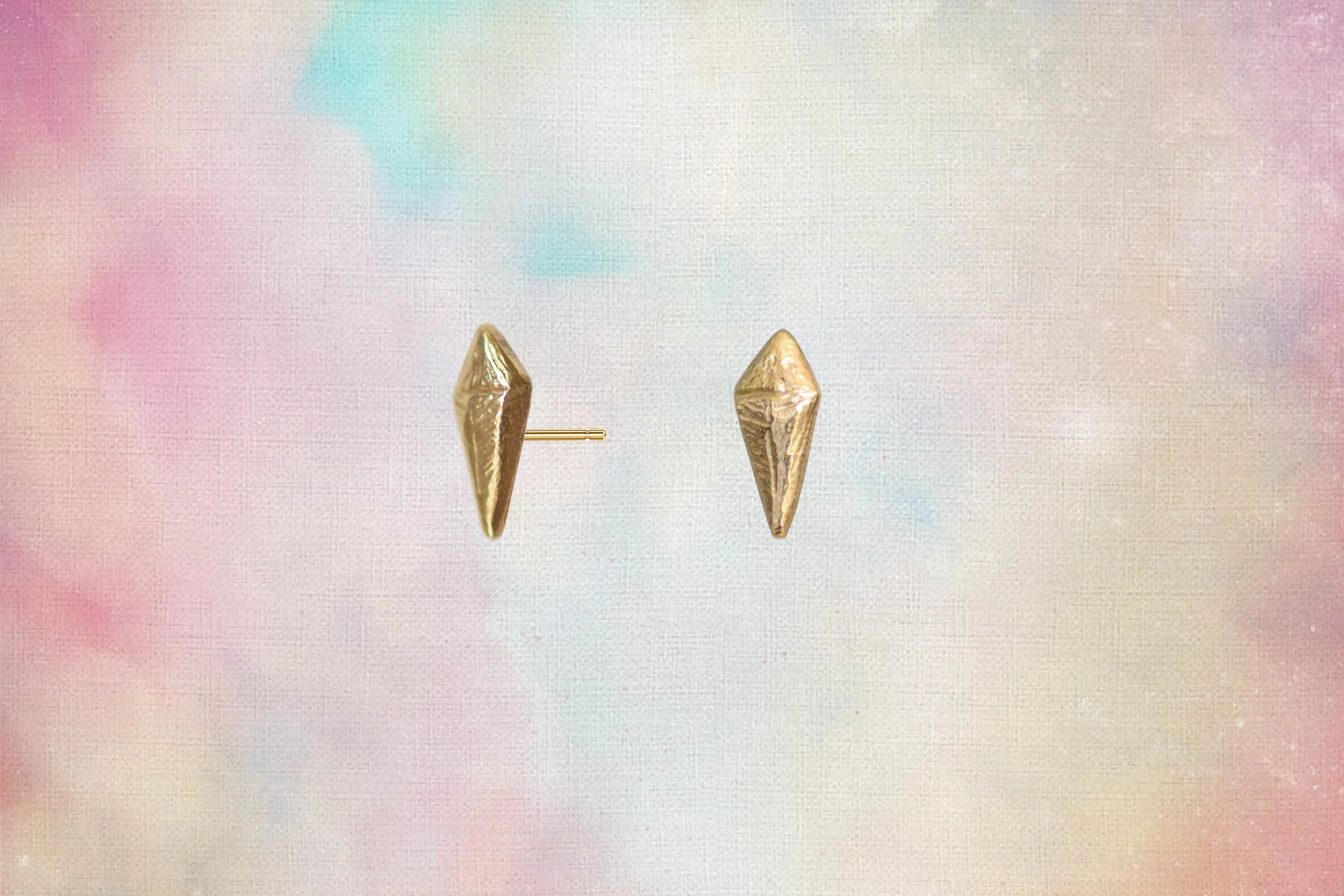 pair of gold kite stud earrings shown front and side view