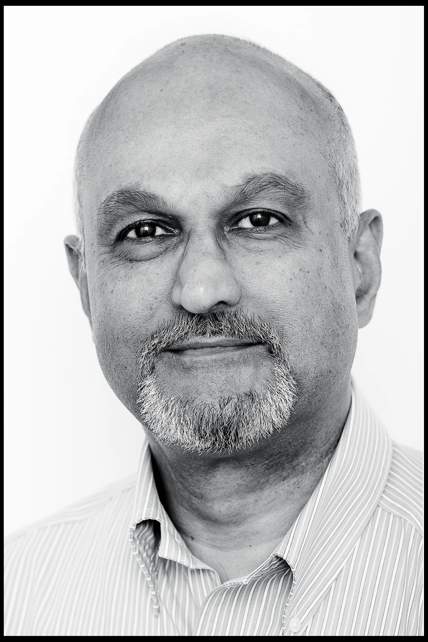 corporate headshot of a man with a beard