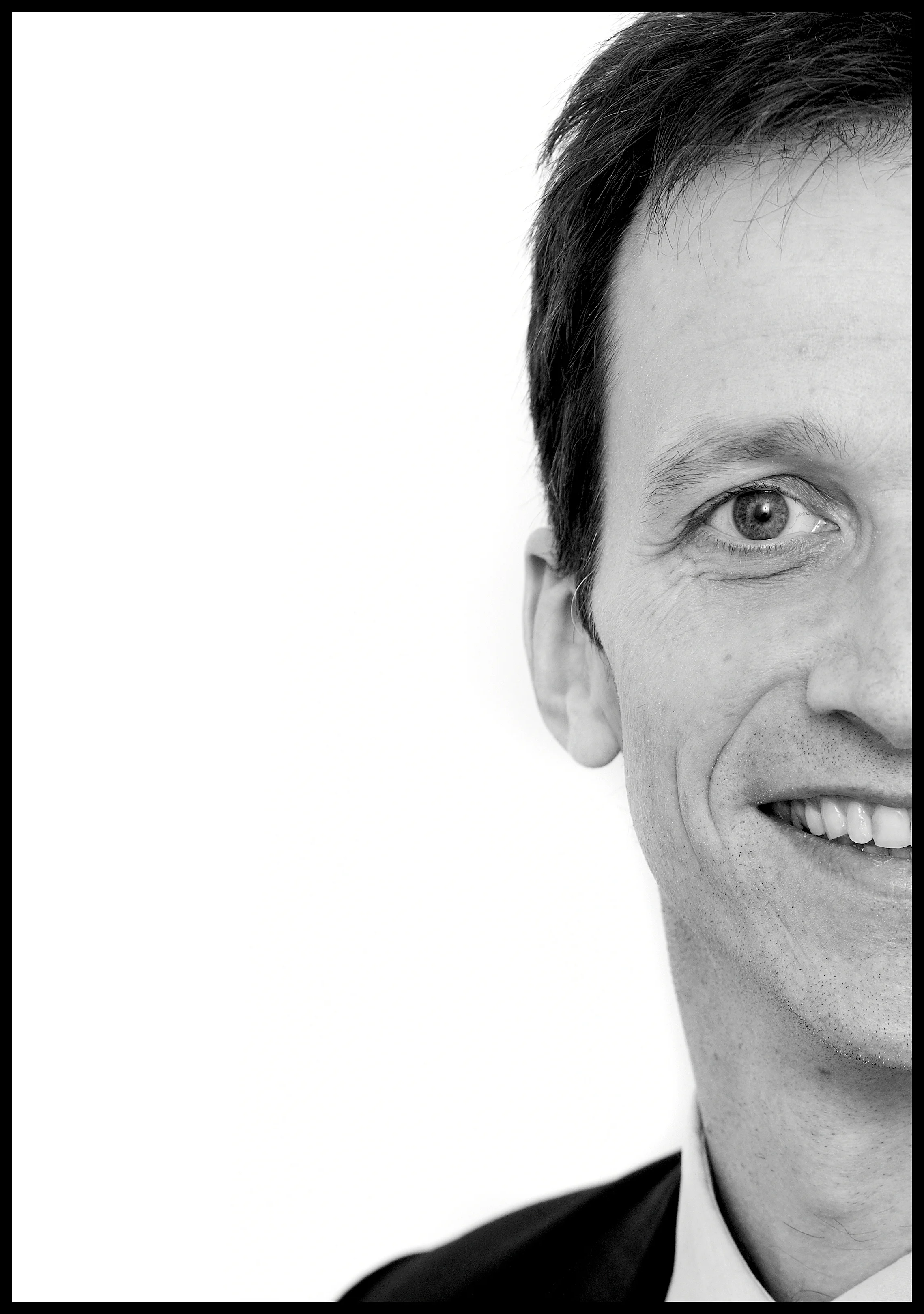 quirky corporate headshot of businessman smiling