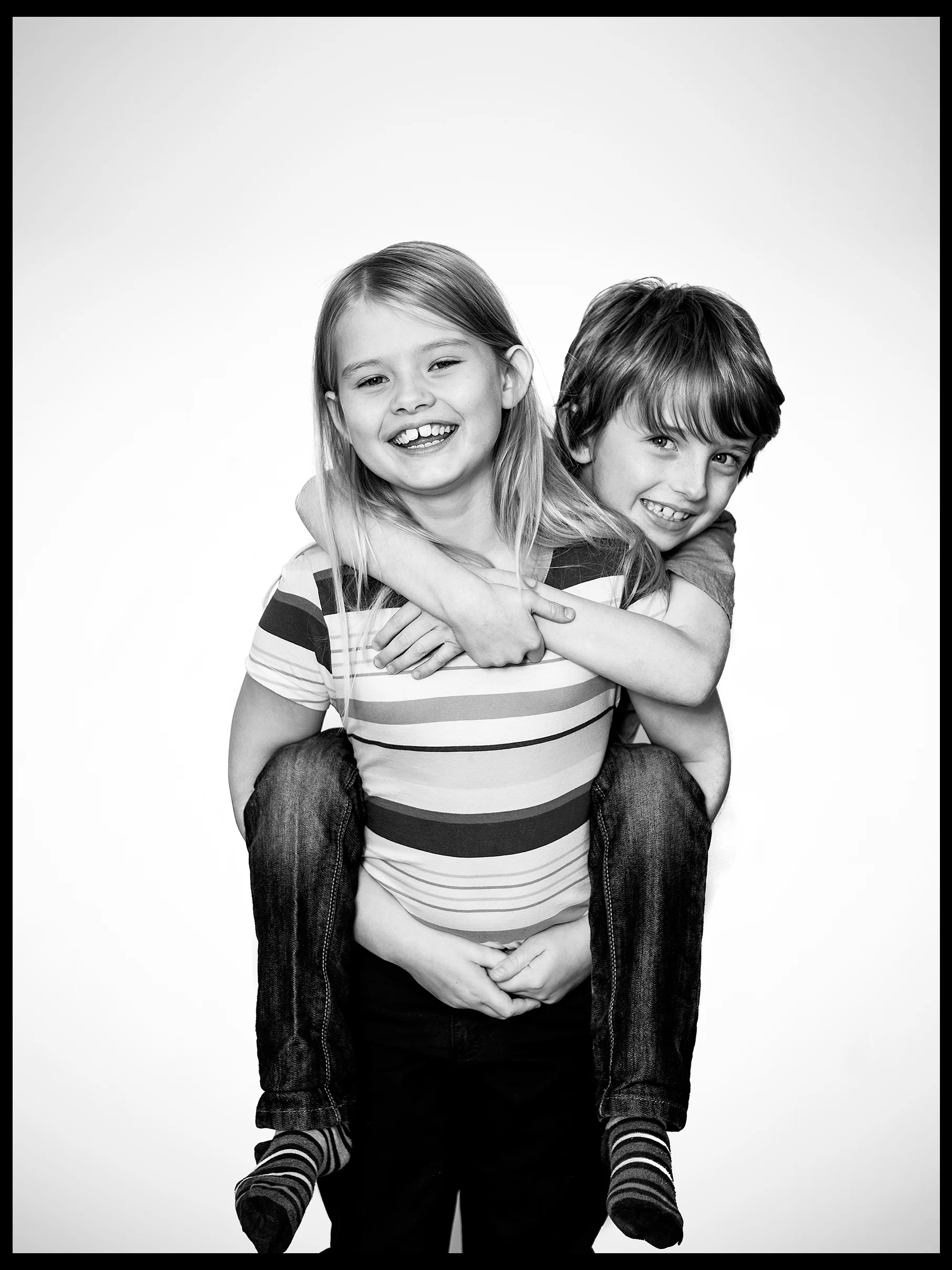 family portrait of young girl with her brother on her back