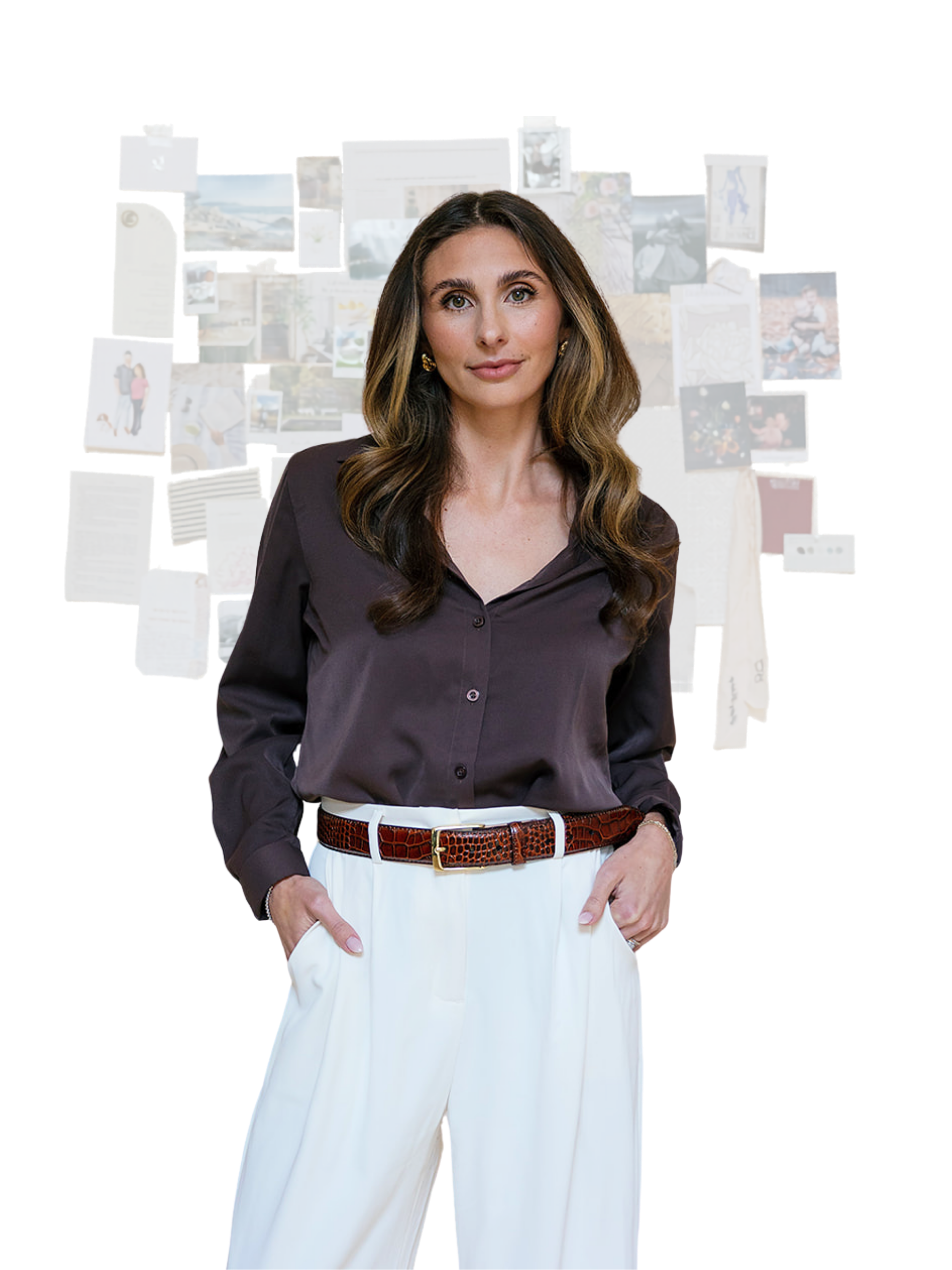 A woman with long wavy brown hair wearing a dark brown button-up shirt and white pants, standing in front of a collage of photographs and notes on a wall.