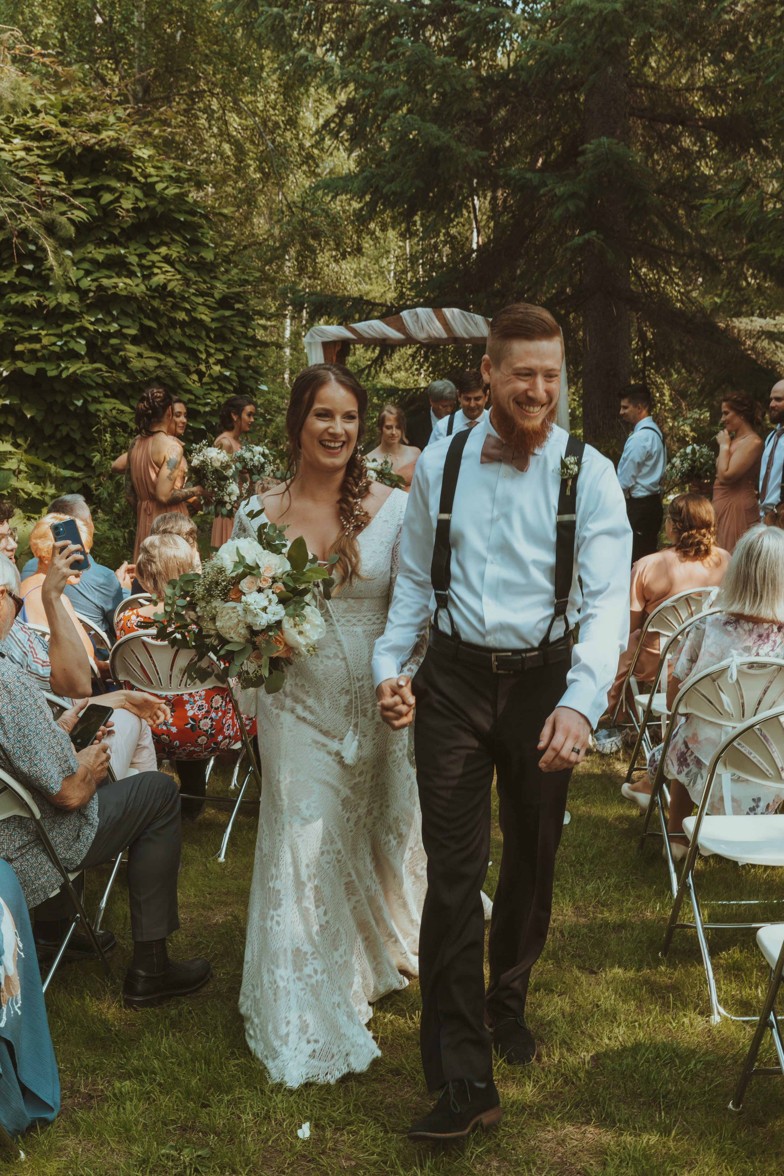 Bride and Groom walk down the aisle at Forget me knot nursery