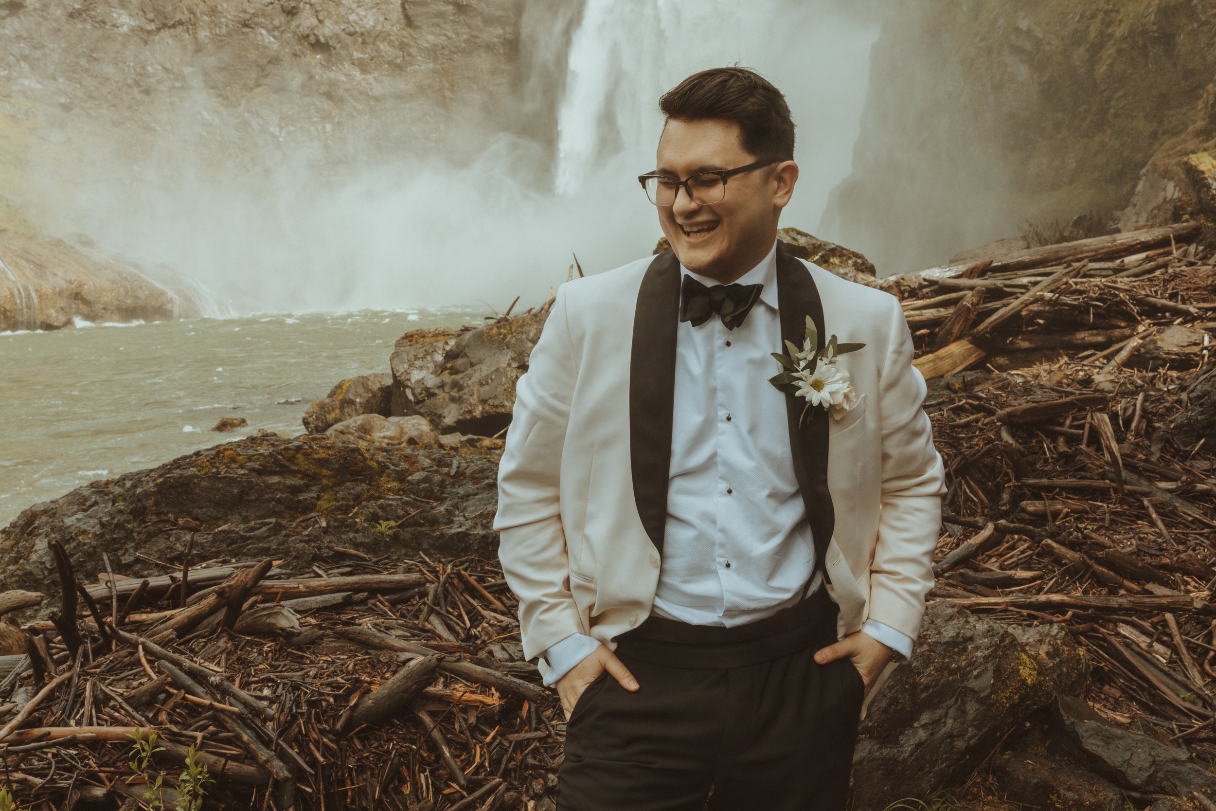 Groom Poses in front of Snoqualmie Falls