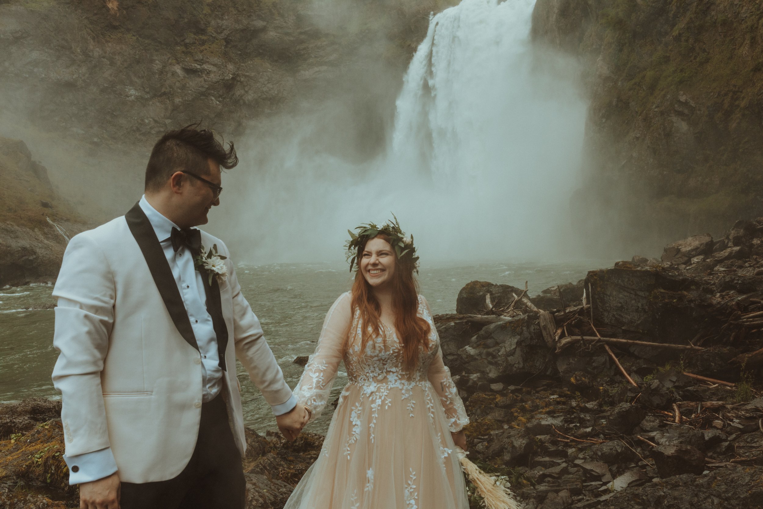 Bride and Groom Pose in front of Snoqualmie Falls