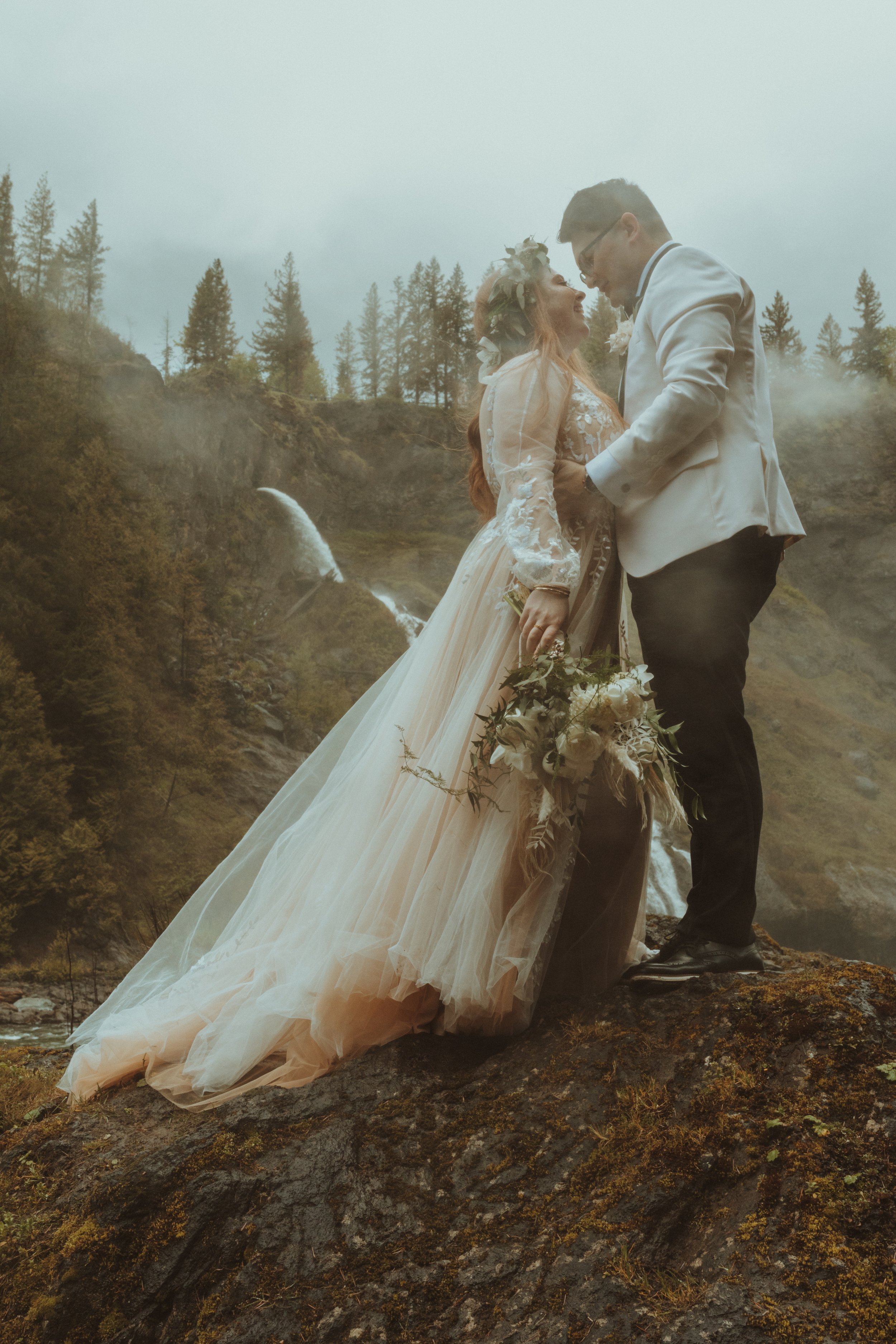 Bride and Groom Pose in front of Snoqualmie Falls