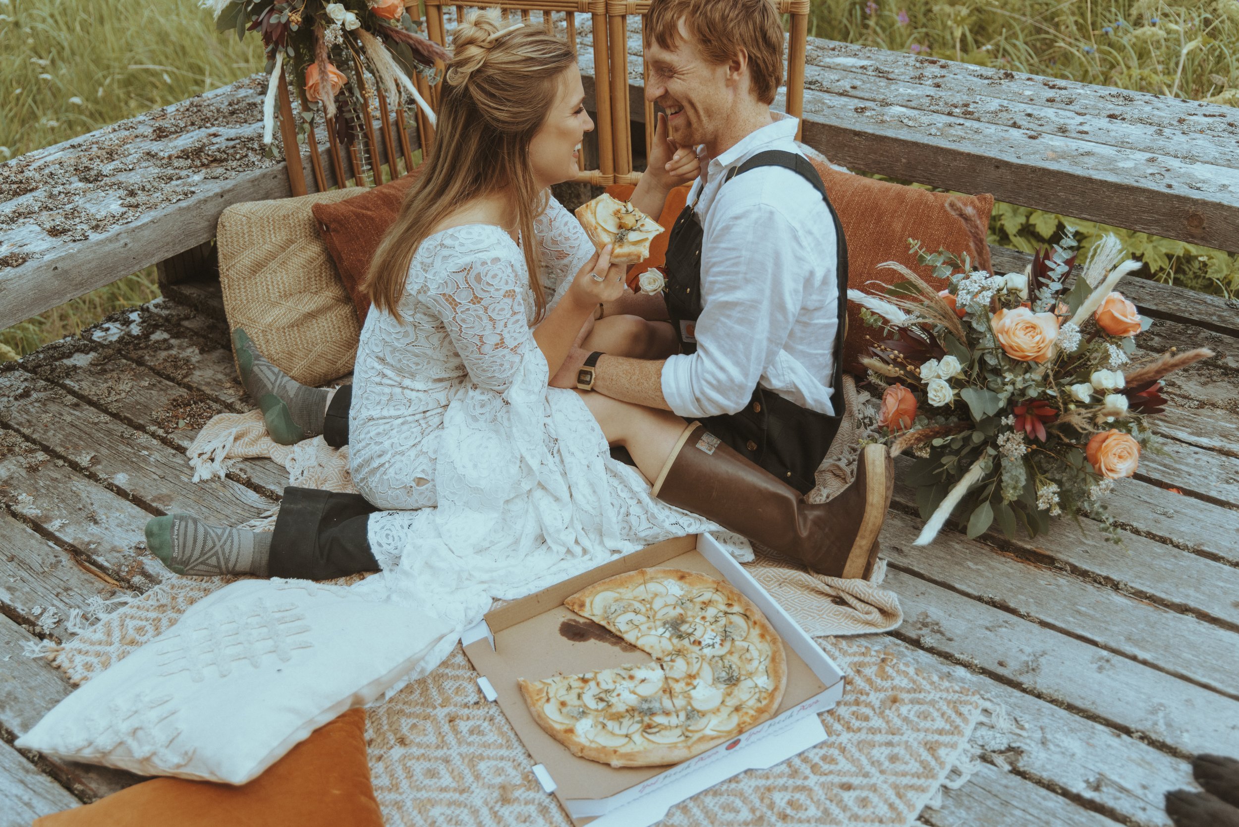 Bride and Groom Share a Slice of Pizza