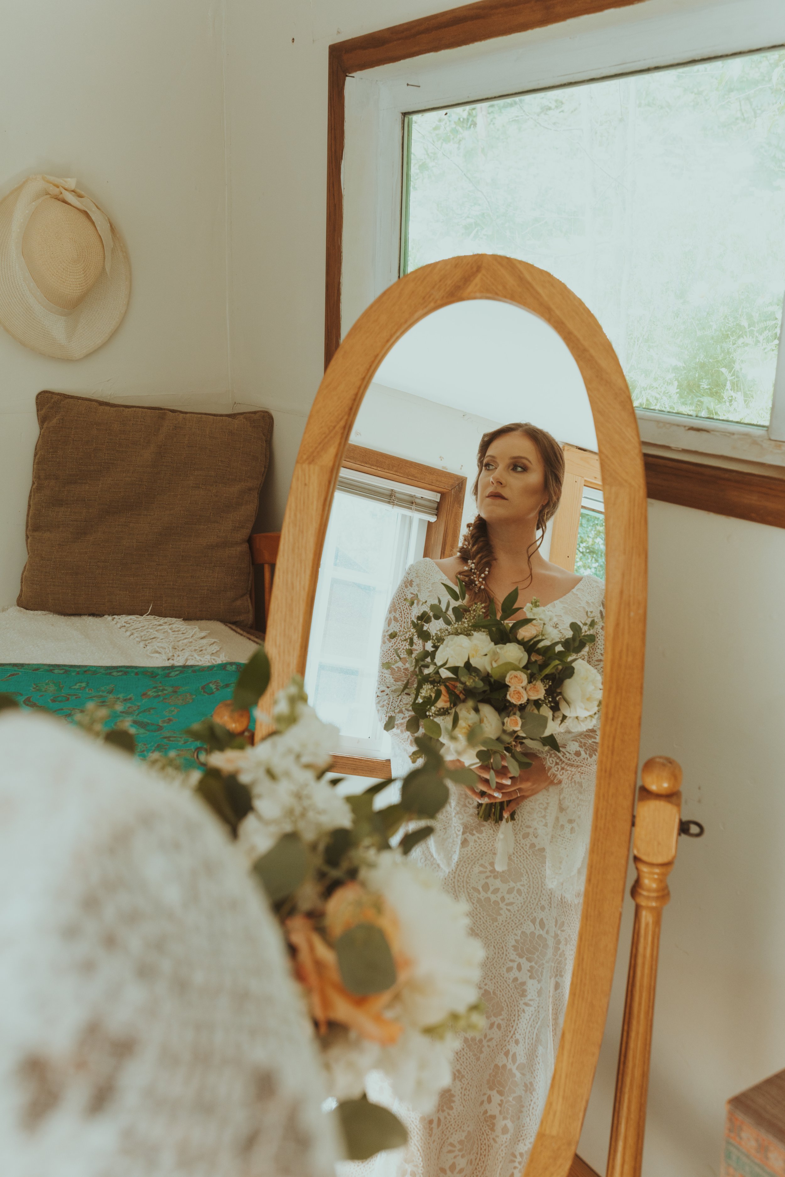 Bride looks into mirror