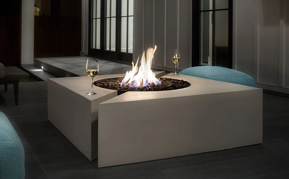 Chaos square fire feature with birch finish lit at night