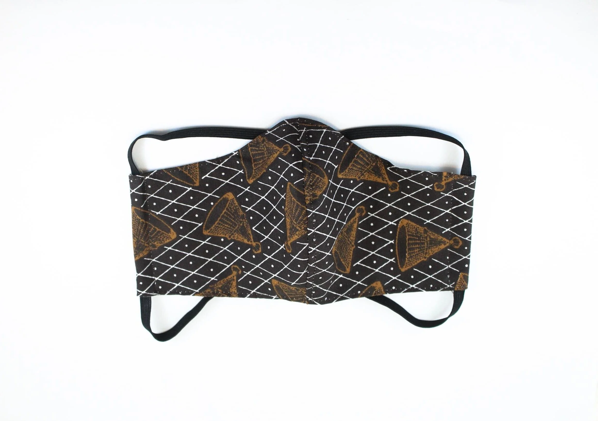 A black and white face mask with brown cones