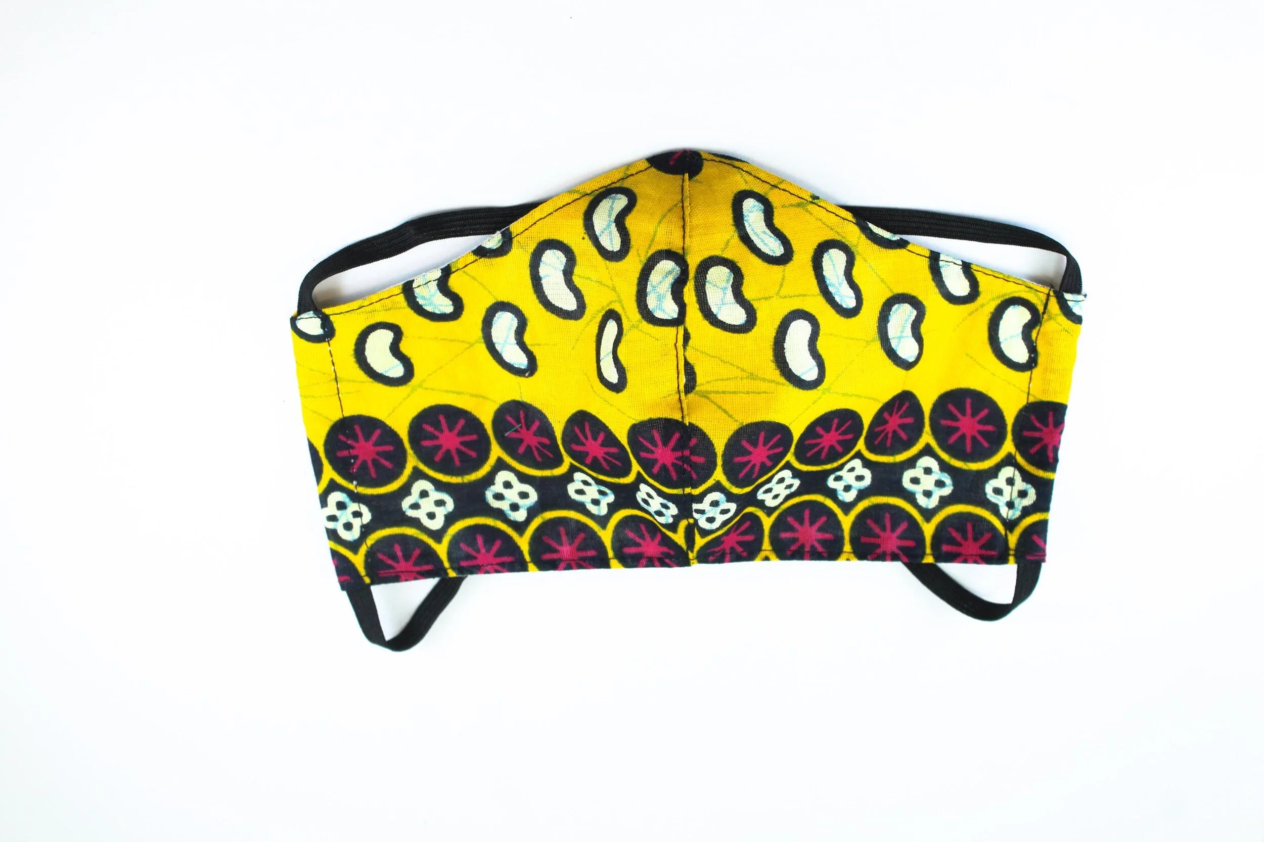 A yellow face mask with red and white emblems