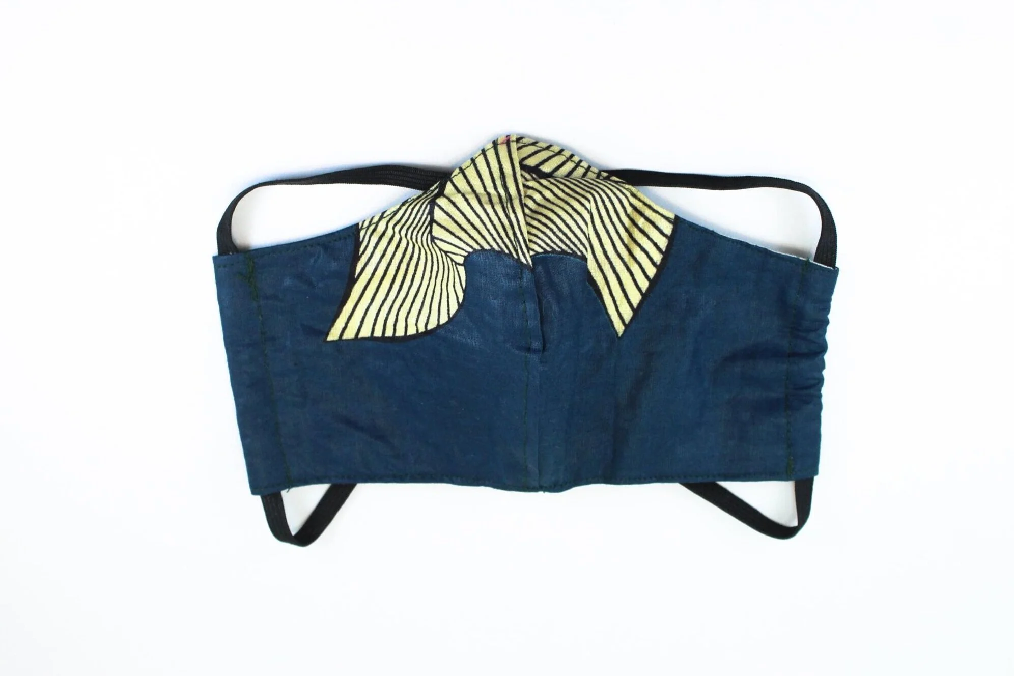 A blue face mask with cream and black stripes