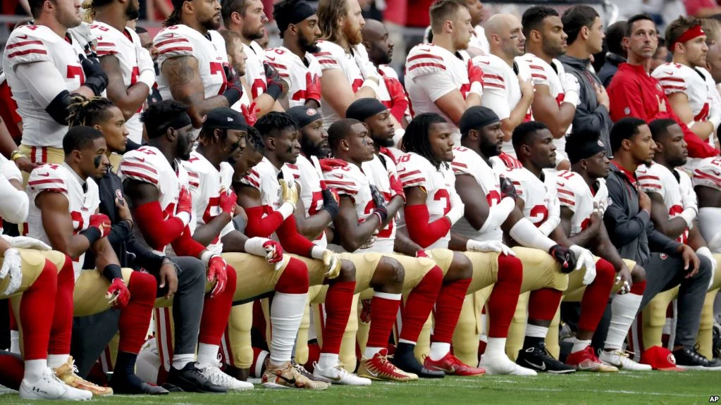 San Francisco 49ers take a knee during the national anthem