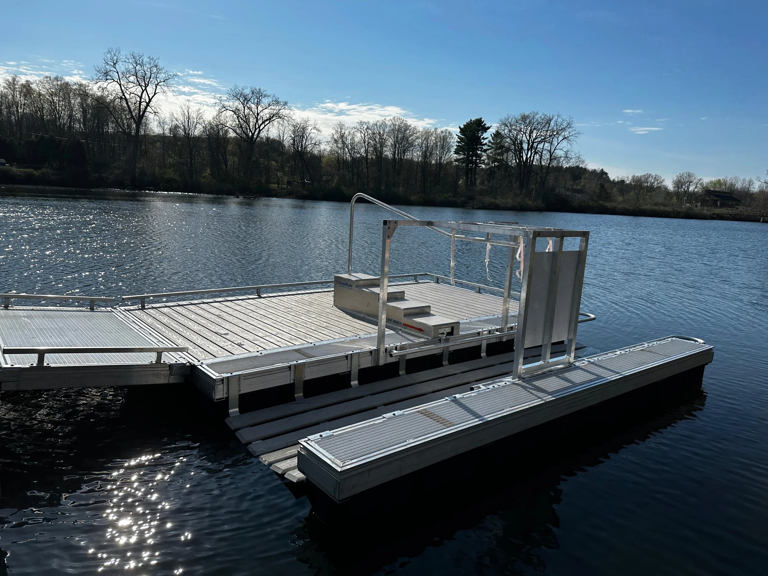 A steel adaptive kayak launch that features steps and handrails for support.