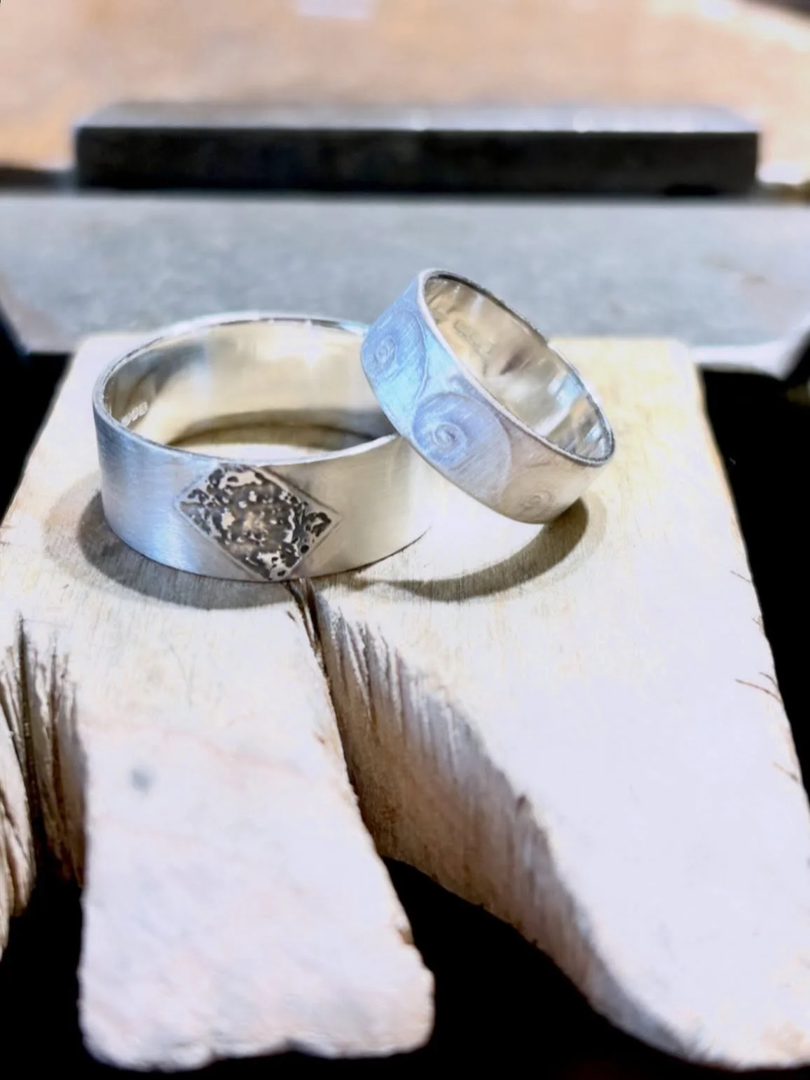 Special pair of Wedding bands collected yesterday, heading up to the Isle of Harris for a very special couple. 
For Her: Fibonacci Golden Spiral Band
For Him: a personal image of a Garnet slice transformed into an etched section. 
Both with a subtle 