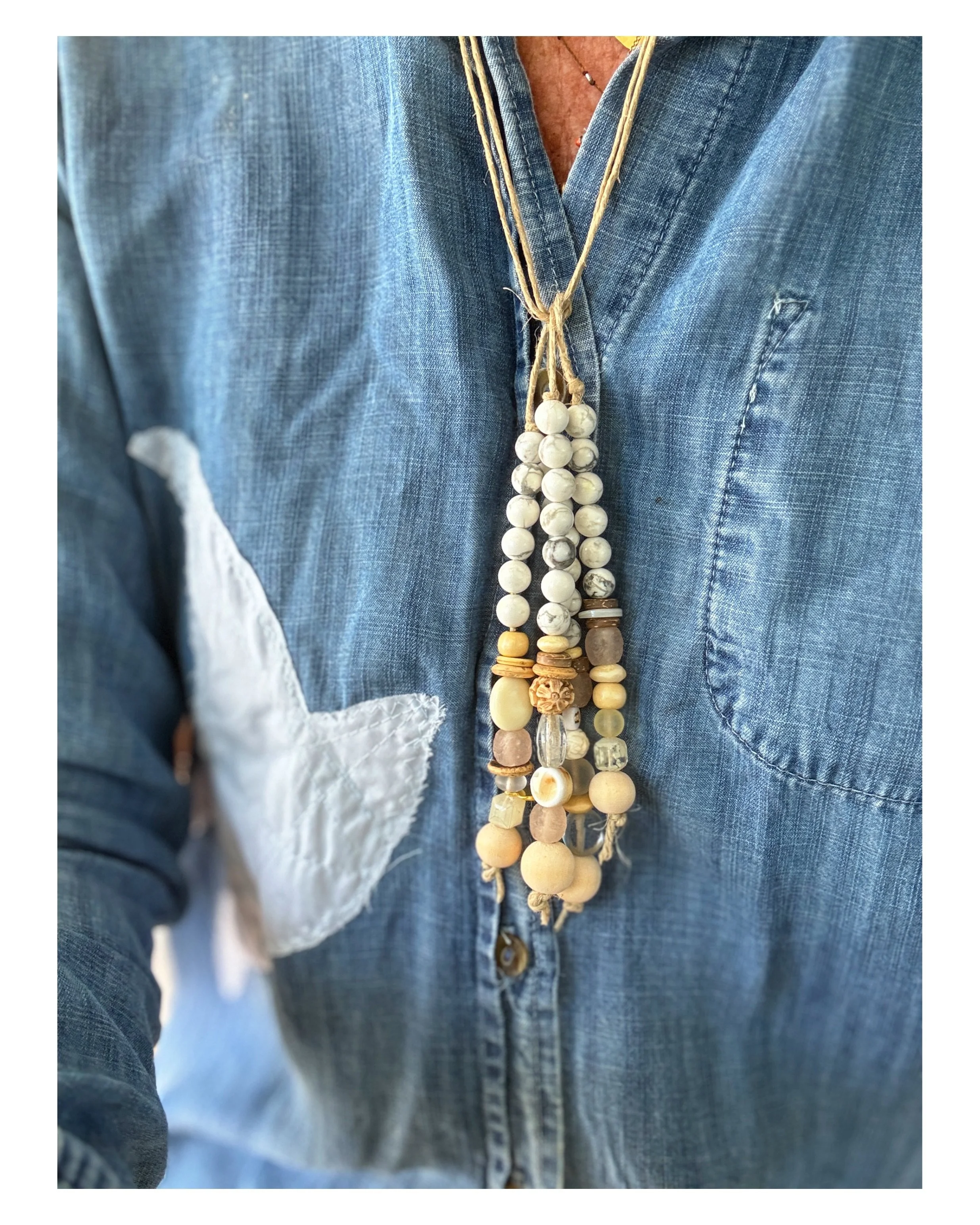 The Island Necklace ✨🌼🩵🌊✨ is made with howlite stone and wood, carved beads, and pink glass. I was drawn to howlite  as a healing and natural stone known to calm the mind, and spirit, promoting wisdom, raising awareness, and granting clear vision&