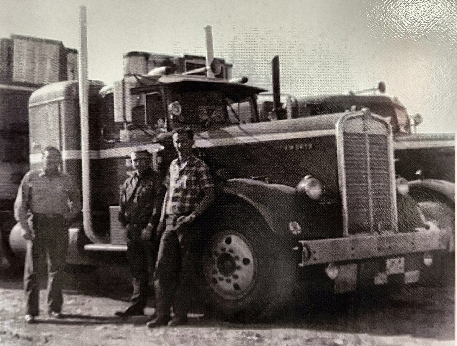 Three drivers standing beside an early Digby truck