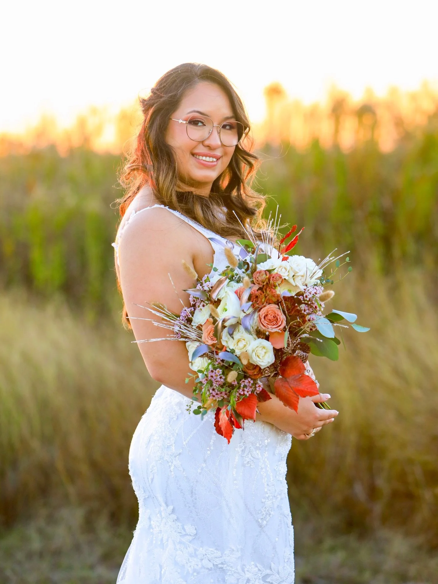 During golden hour, a bride&rsquo;s portrait transforms into something almost ethereal&mdash;bathed in soft, warm light that gently wraps around her silhouette. The sun&rsquo;s low glow enhances the delicate details of her dress, veil, and bouquet wh