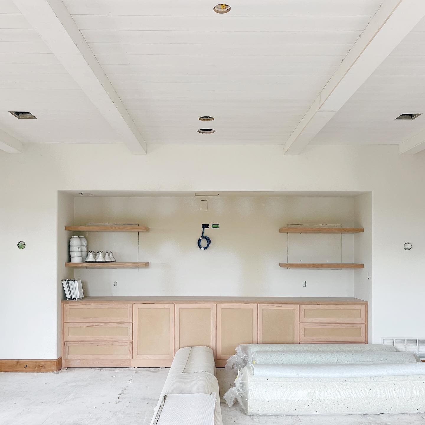 Family/media room in progress 👉🏻 compared to the before. 🔨 | Tongue &amp; groove paneling and 4 beams were added to the ceiling + an updated cabinetry design. It&rsquo;s not in yet, but cane will be added to the lower cabinets and drawers for some