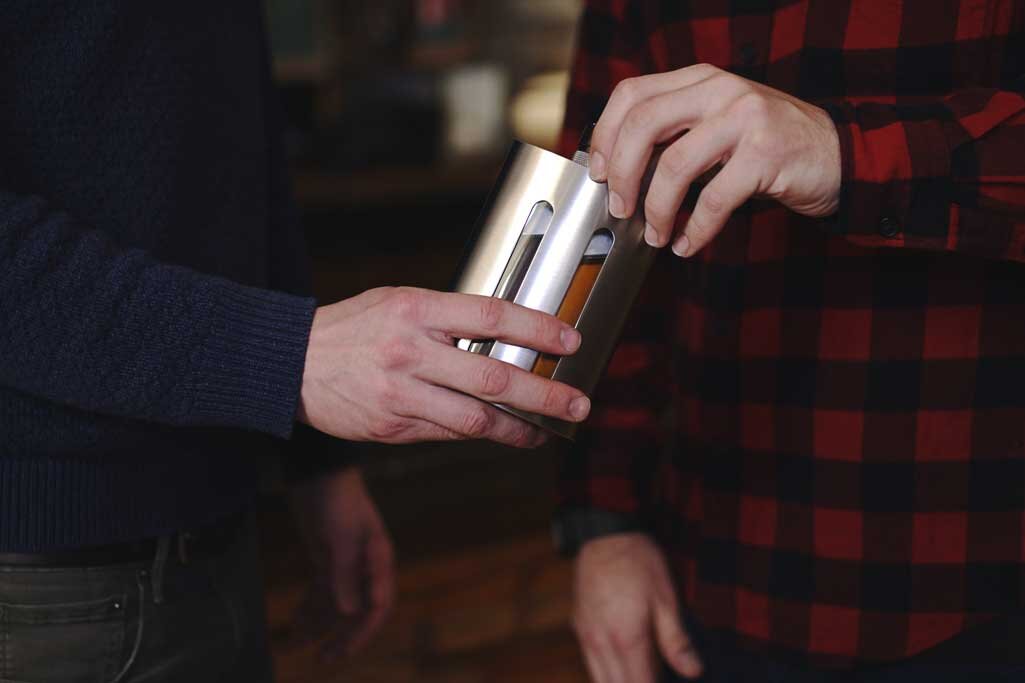 Father-passing-son-dual-chambered-Fusion-Flask-with-two-seperate-beverages-in-flask.jpg