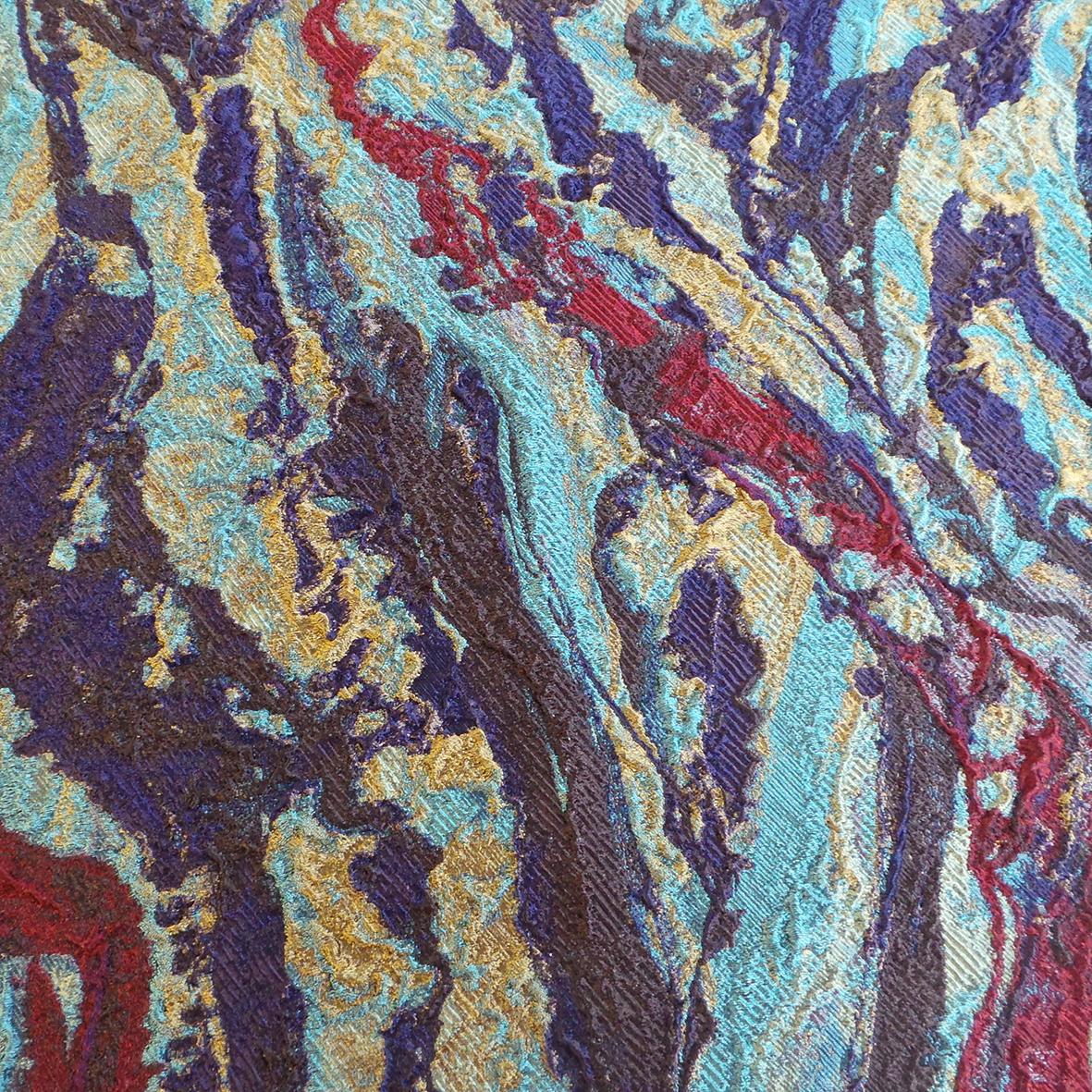 a textural abastract cloque with red, yellow, teal, purple and brown
