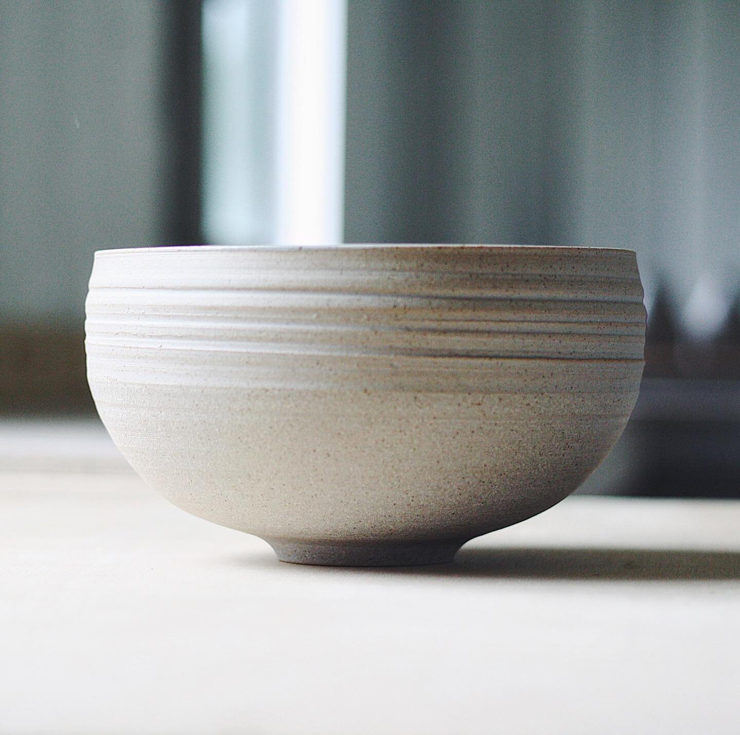 Bellied bowl, grey stoneware with matte white interior. Annoyingly un-stackable, happily rounded and functional.