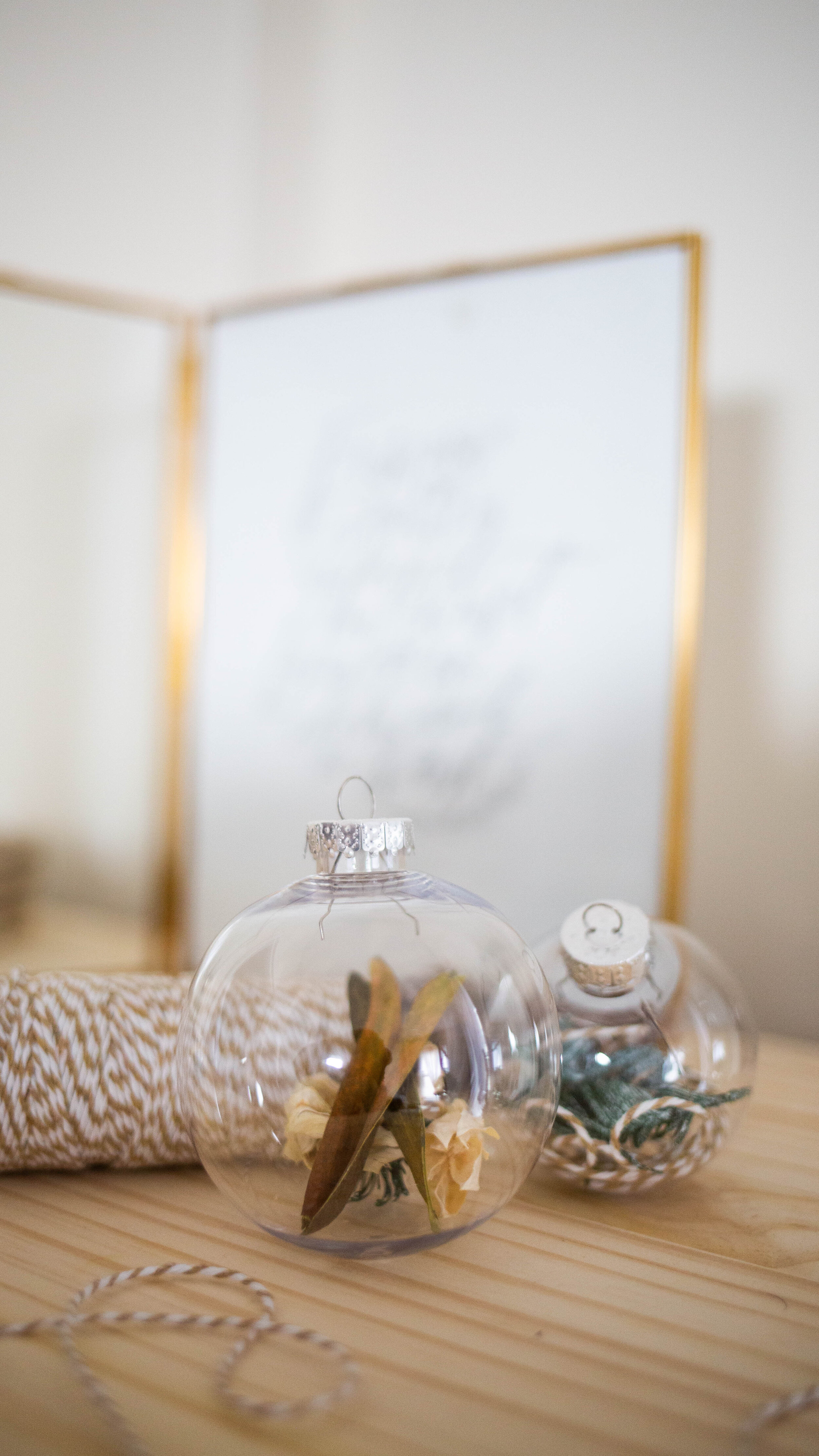 Clear ornaments, twine, and greenery for a neutral Christmas pallet 