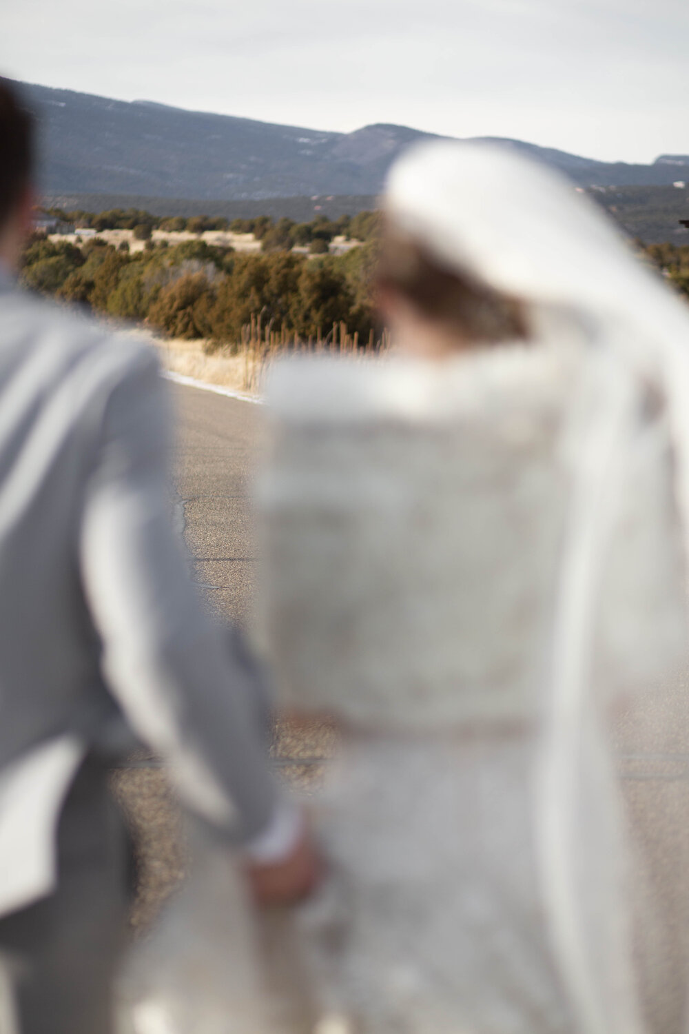 Blurry shot of bride and groom in the mountains 