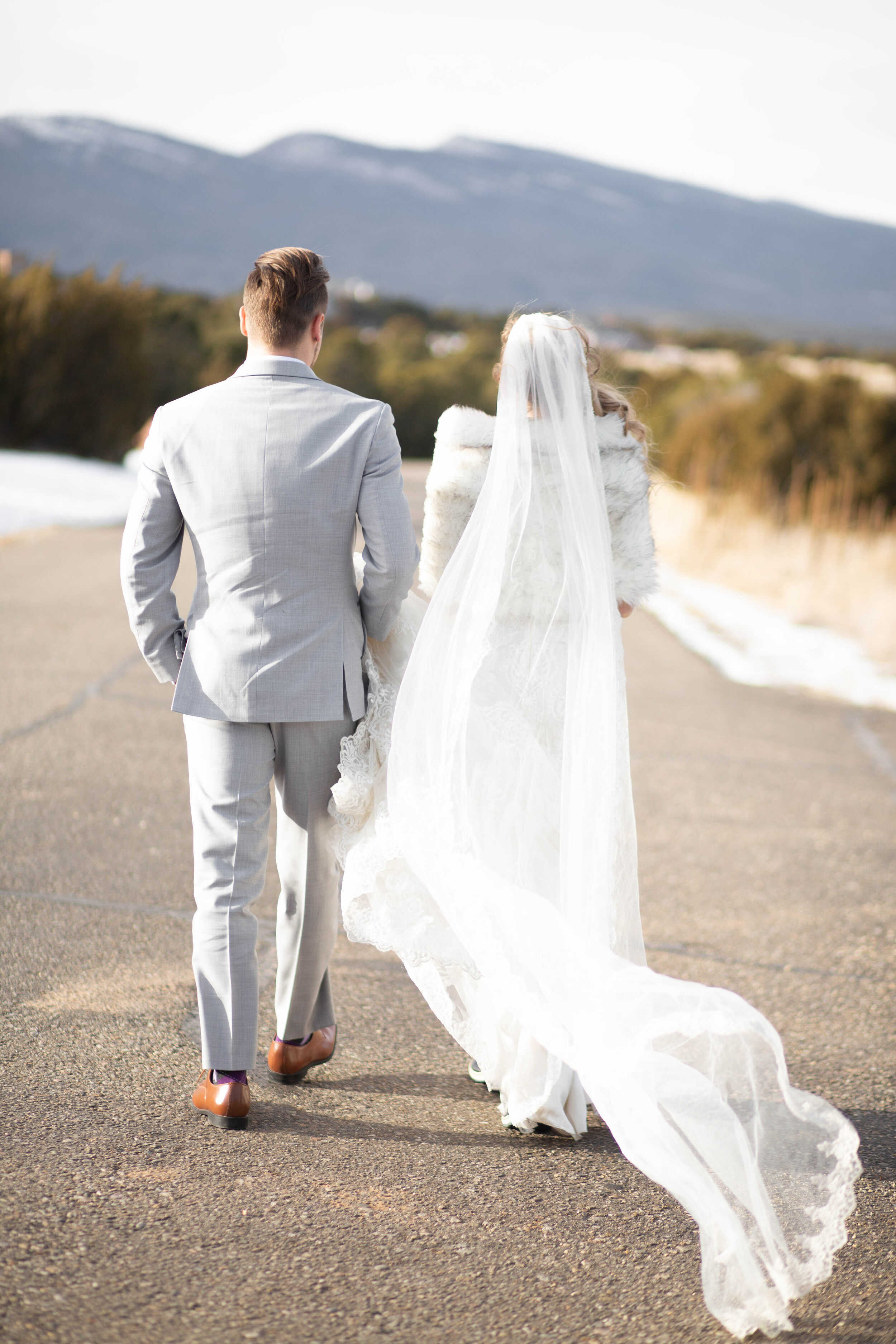 Bride's veil blowing in the wind perfectly behind her 