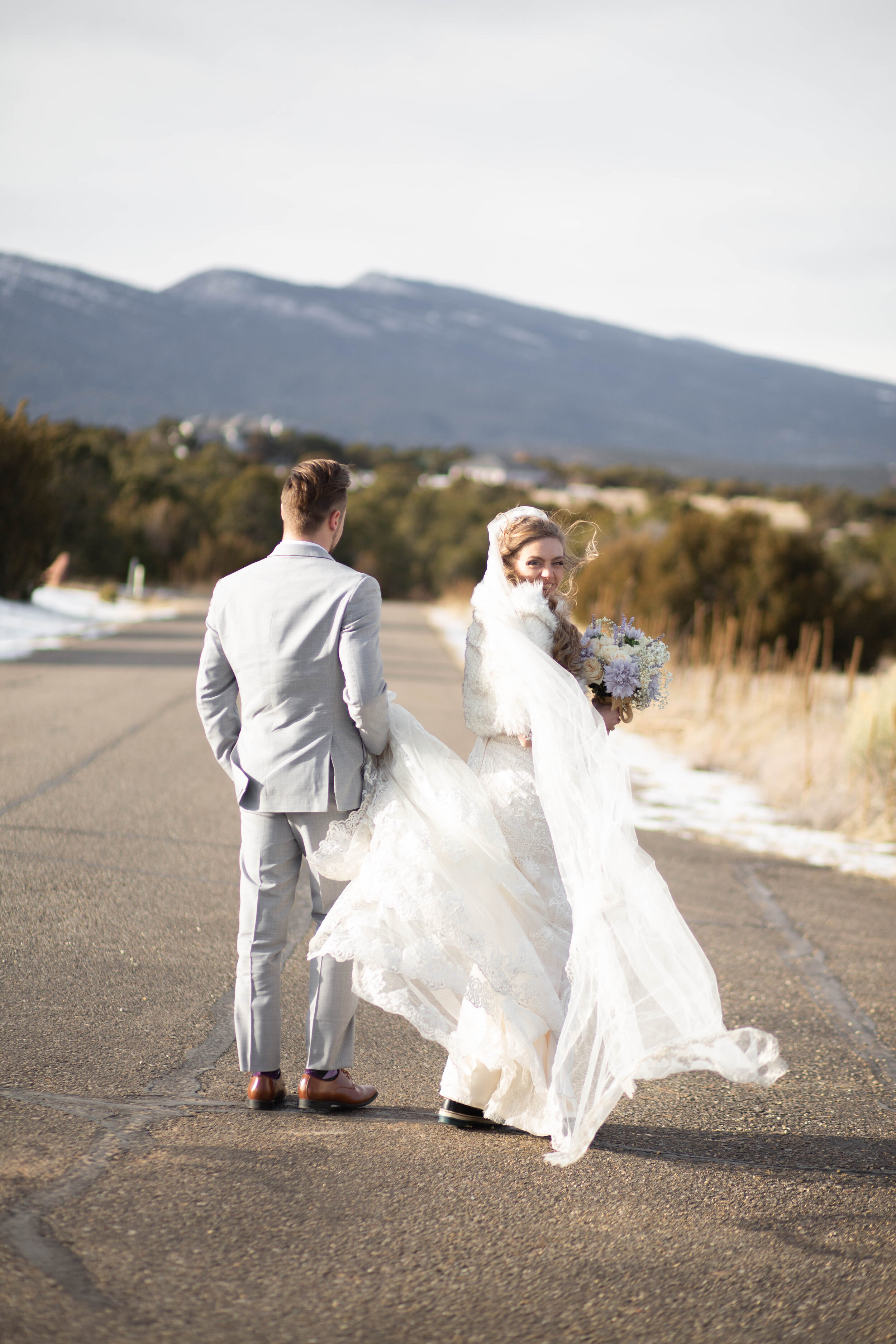 A long veil blowing in the wind on a romantic walk through the Albuquerque mountains