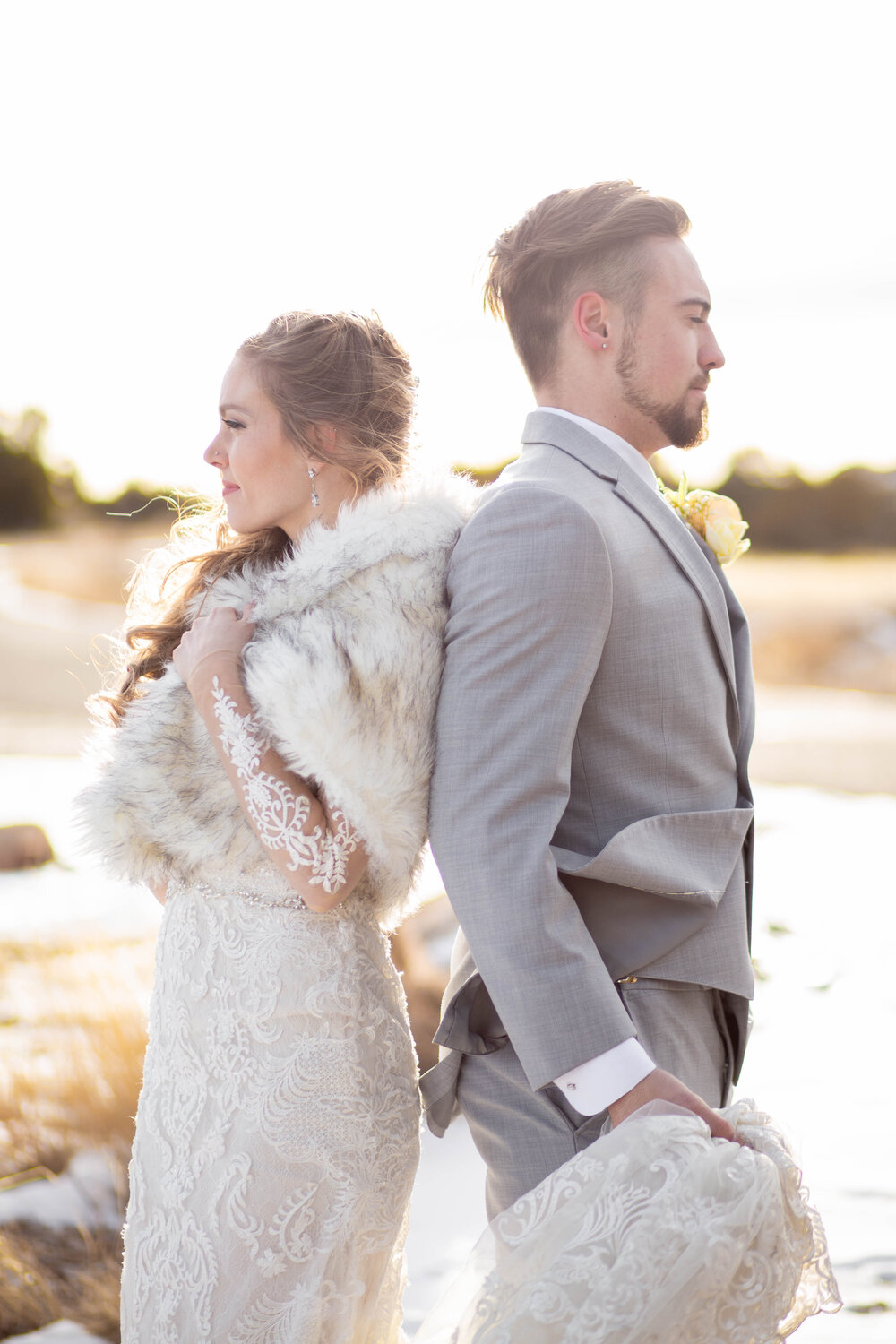 Elegant bride wears a fur wrap in snowy wedding portraits by The Vow Collective 