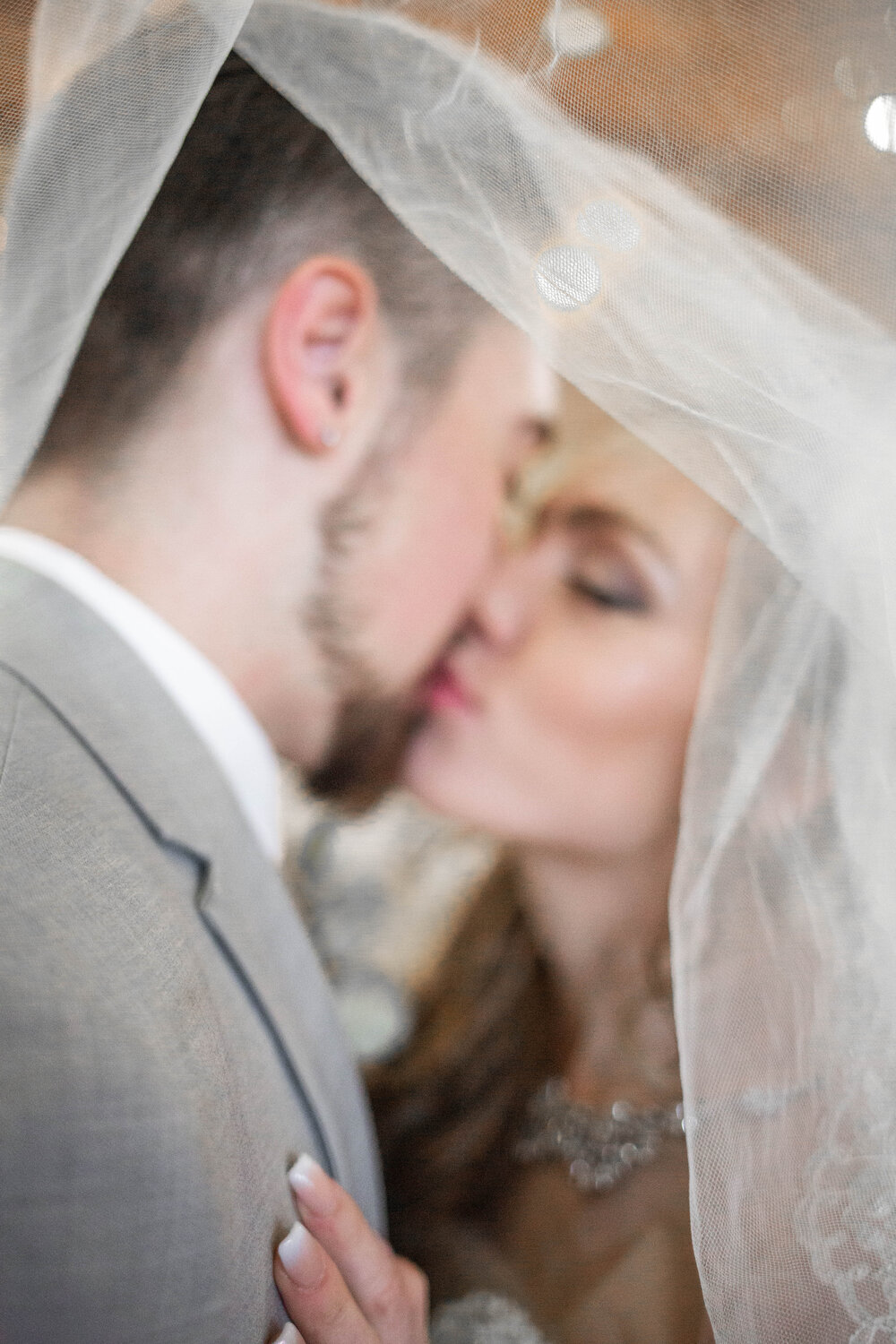 kissing under the veil at Nature Pointe with The Vow Collective 