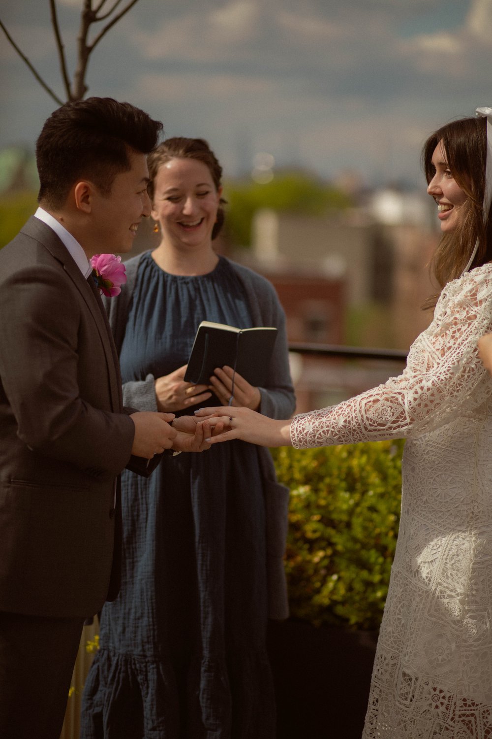 A heartwarming moment captured during the rooftop ceremony in Brooklyn, New York City. Katie and Stan exchange looks filled with genuine love and admiration.