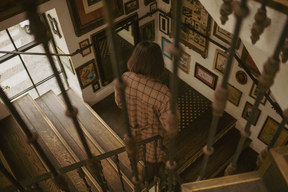 woman walking down stairs in restaurant in france