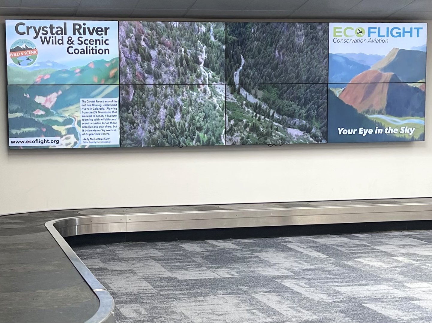 EcoFlight's Aspen Airport Ad showing on the big screens in Baggage Claim. 2023