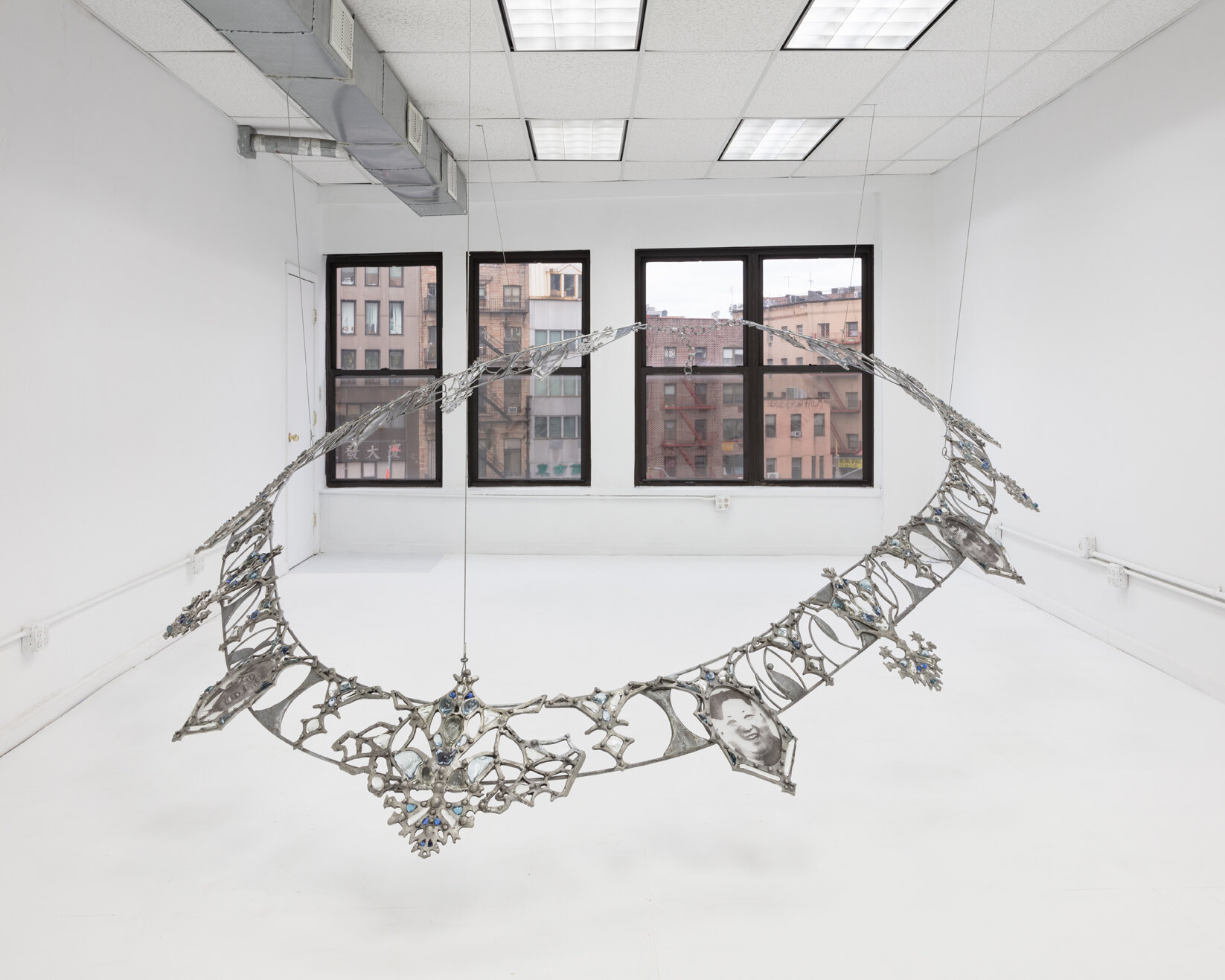   Fallout Necklace , 2018. From the series  Trophies of Abuse.  Patined cast aluminum, patined steel, flame-worked glass, powder printed glass. 84 x 120 x 180 inches. Installation view   at Lubov, New York, 2020. 