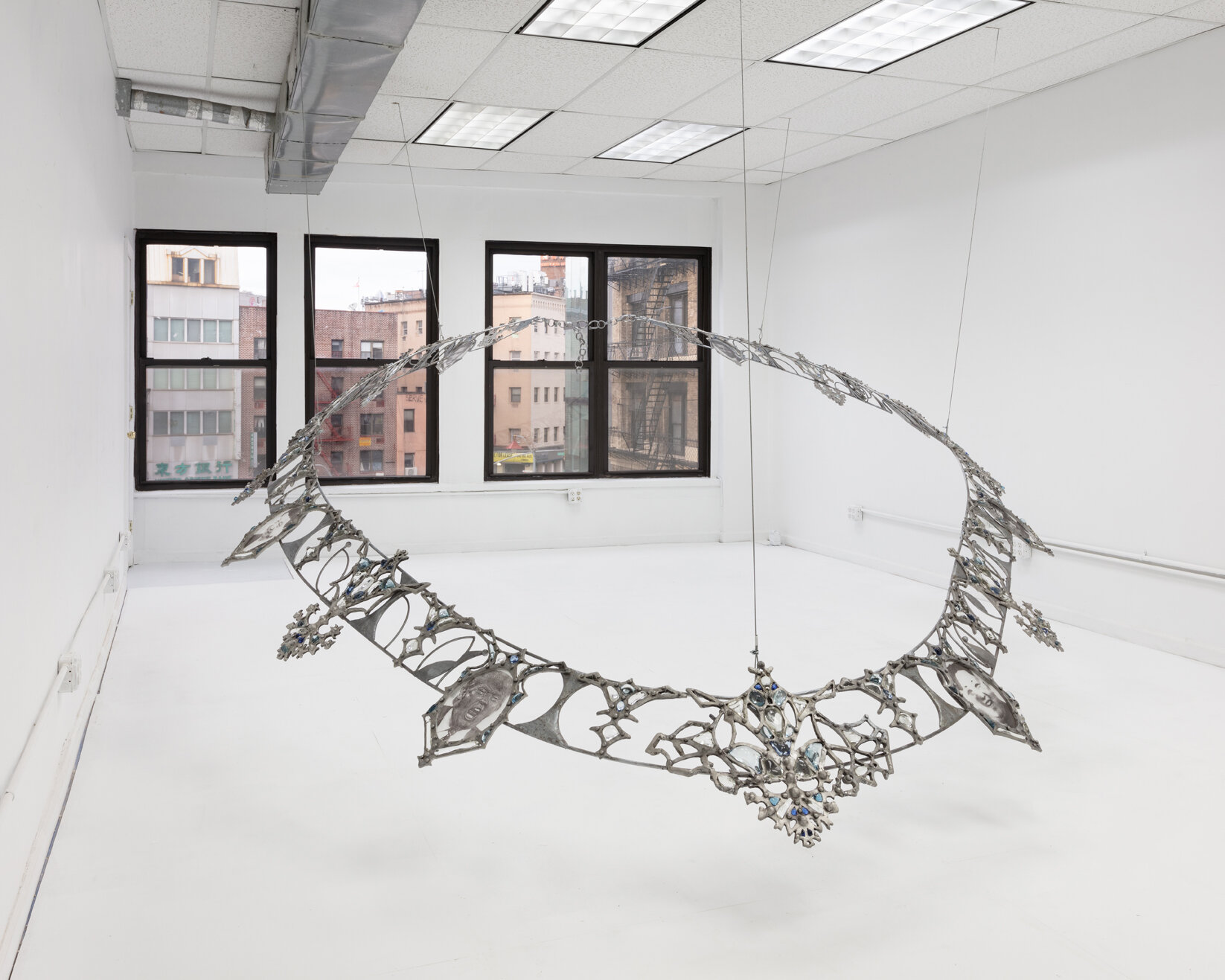   Fallout Necklace , 2018. From the series  Trophies of Abuse.  Patined cast aluminum, patined steel, flame-worked glass, powder printed glass. 84 x 120 x 180 inches. Installation view   at Lubov, New York, 2020. 