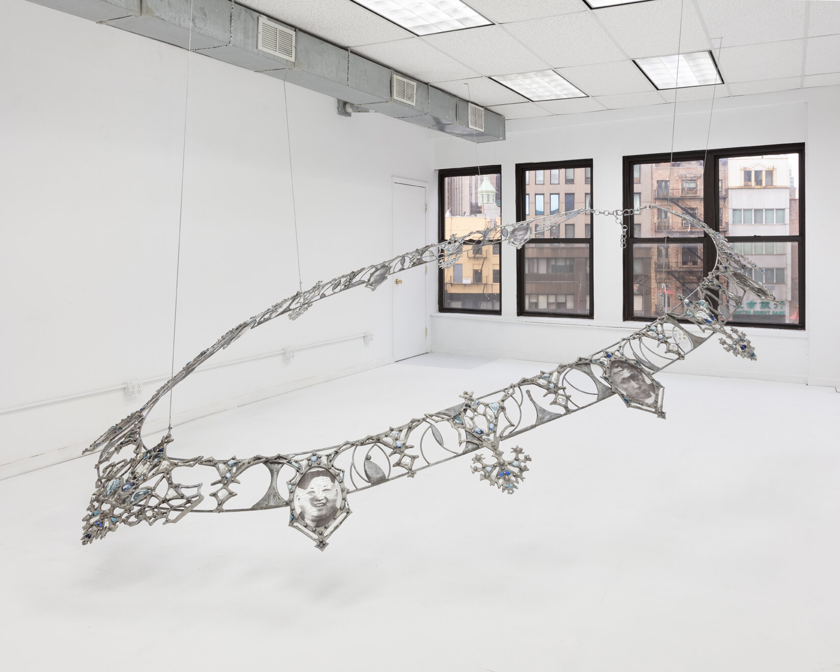   Fallout Necklace , 2018. From the series  Trophies of Abuse.  Patined cast aluminum, patined steel, flame-worked glass, powder printed glass. 84 x 120 x 180 inches. Installation view   at Lubov, New York, 2020. 