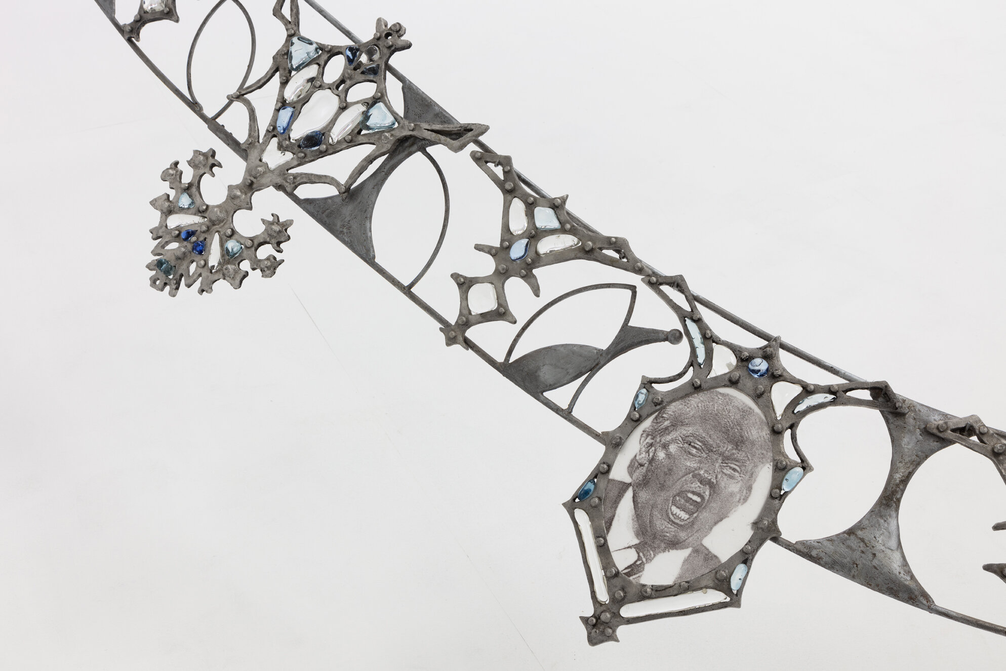   Fallout Necklace  (detail), 2018. From the series  Trophies of Abuse.  Patined cast aluminum, patined steel, flame-worked glass, powder printed glass. 84 x 120 x 180 inches.  